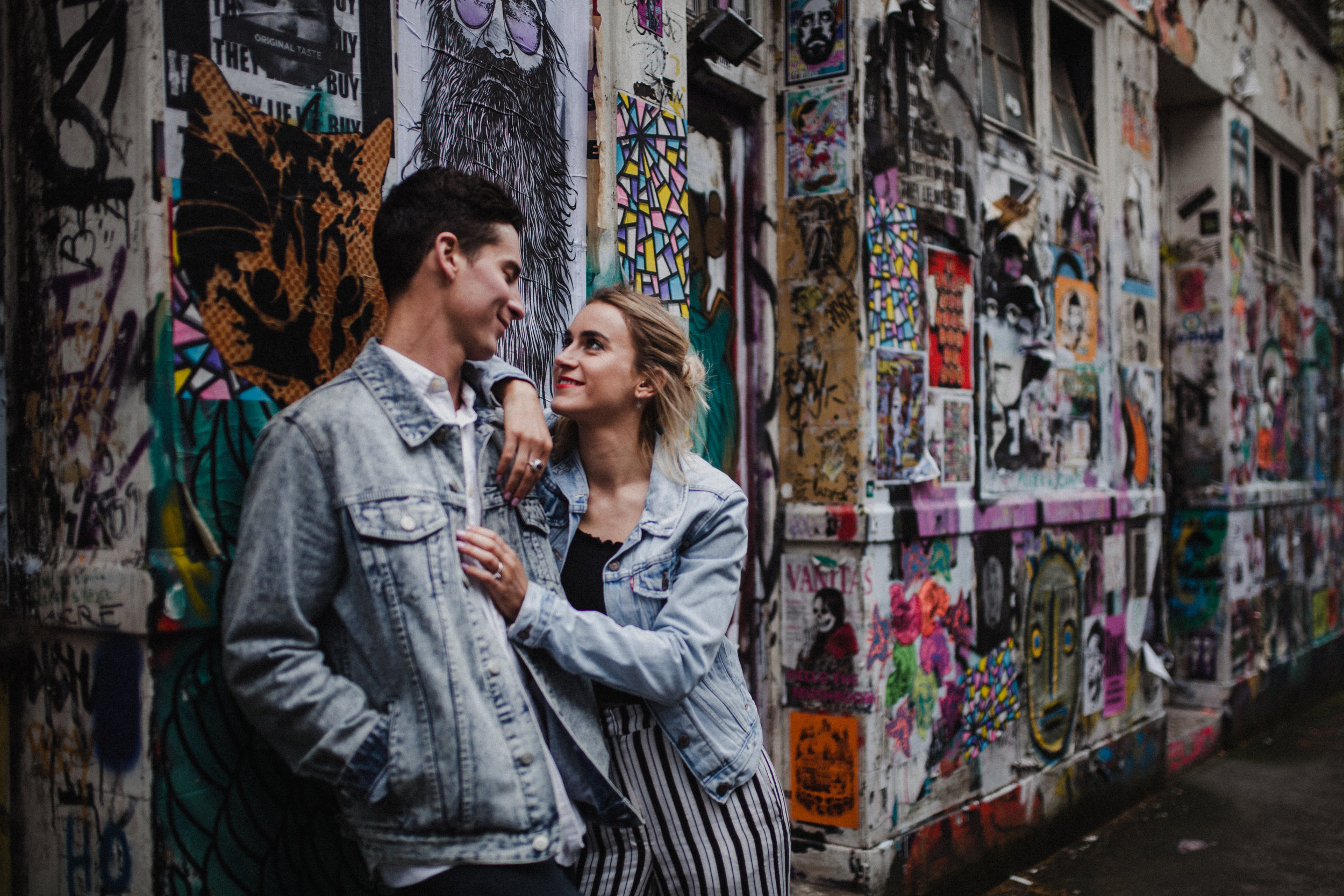 A natural portrait of Petra and Phil with a colourful Brick Lane backdrop.