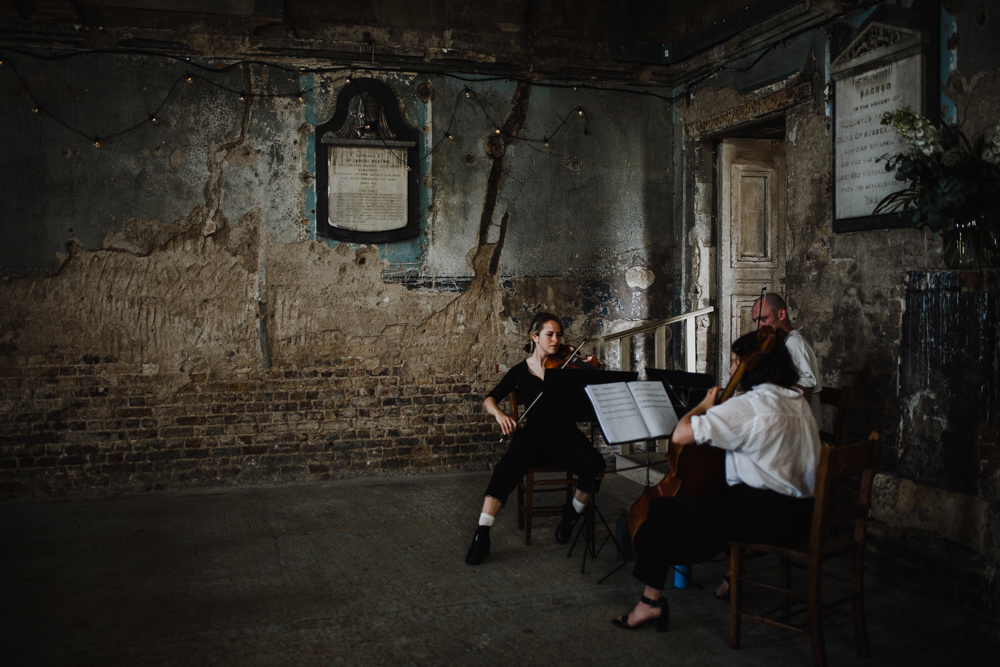 A String trio play as the bride enters for her Asylum Peckham Wedding