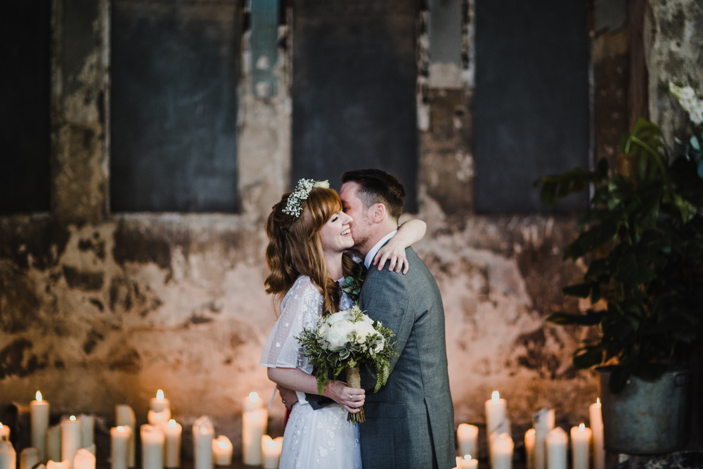 Bride and groom embrace in a hug at the end of the wedding ceremony.