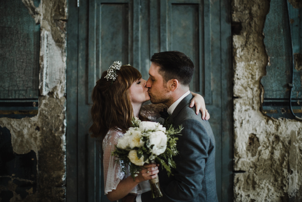 Bride and groom kiss during a moment together after the marriage ceremony.