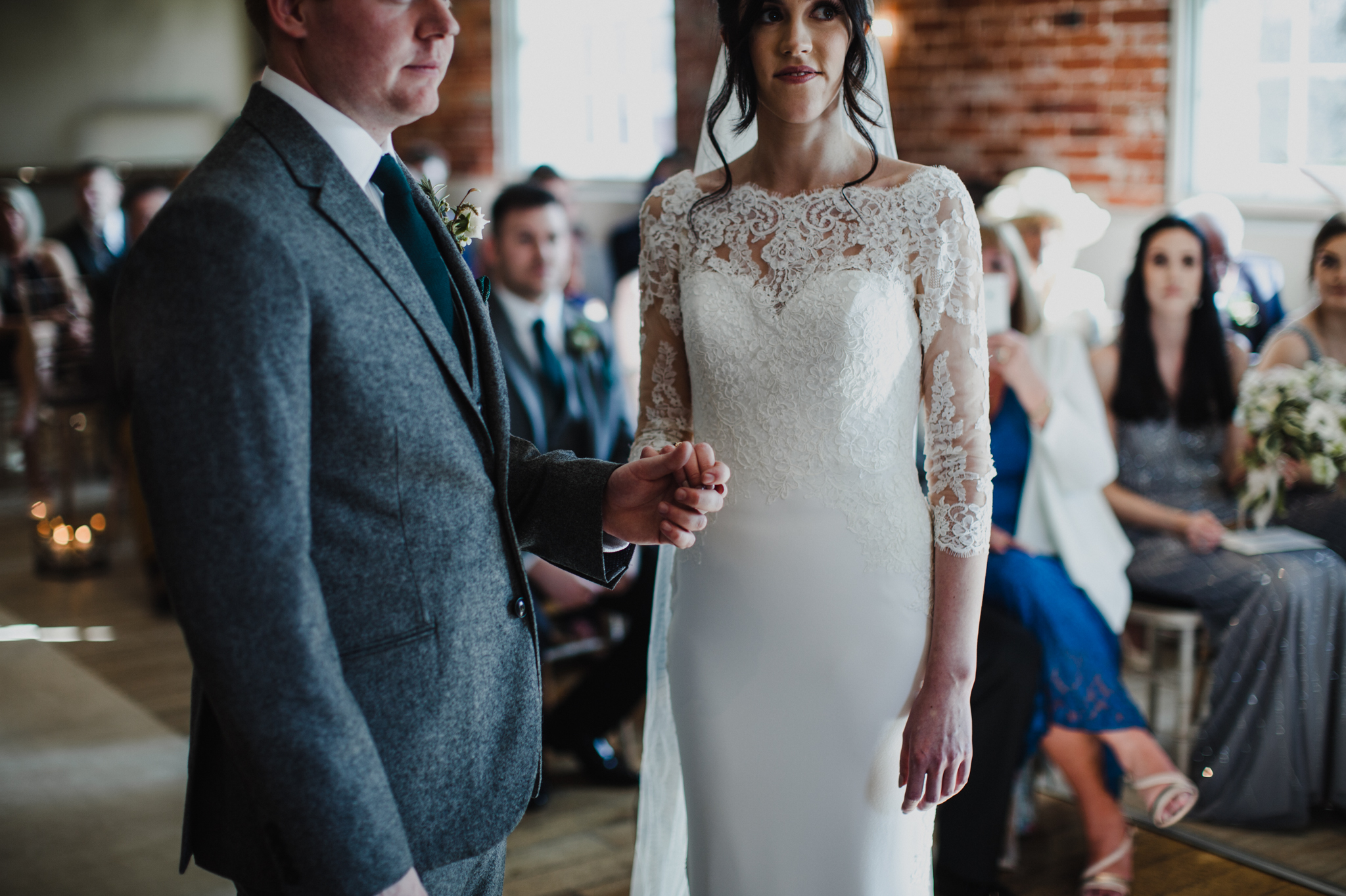 medium view of bride and groom holding hands