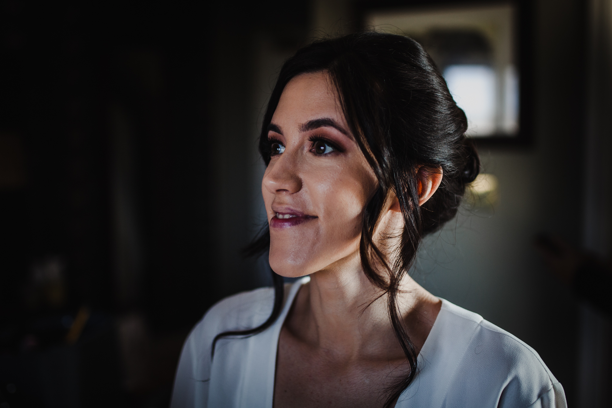 Bride smiling as makeup is finished