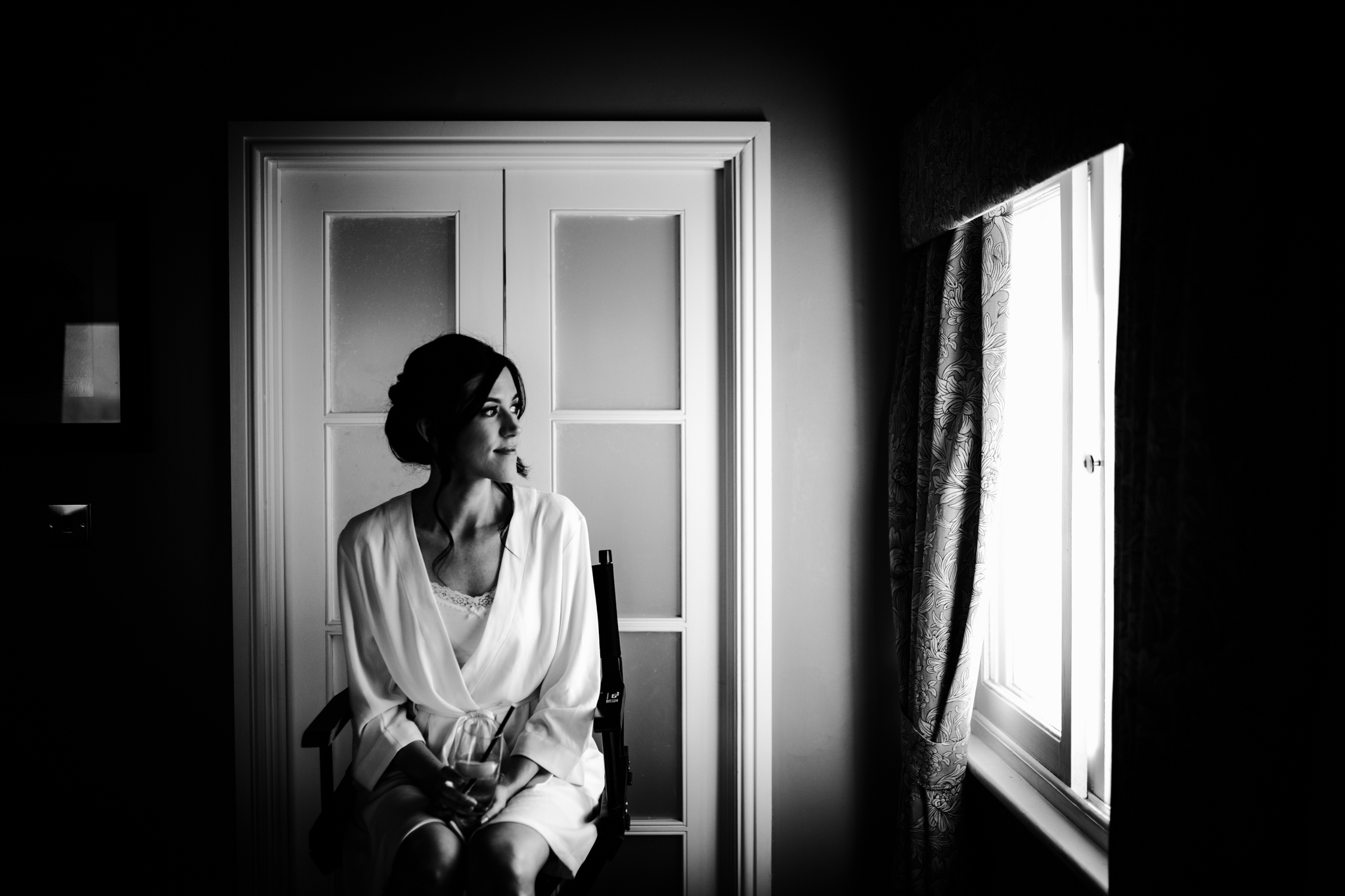 Bride gazing out the window in hotel room