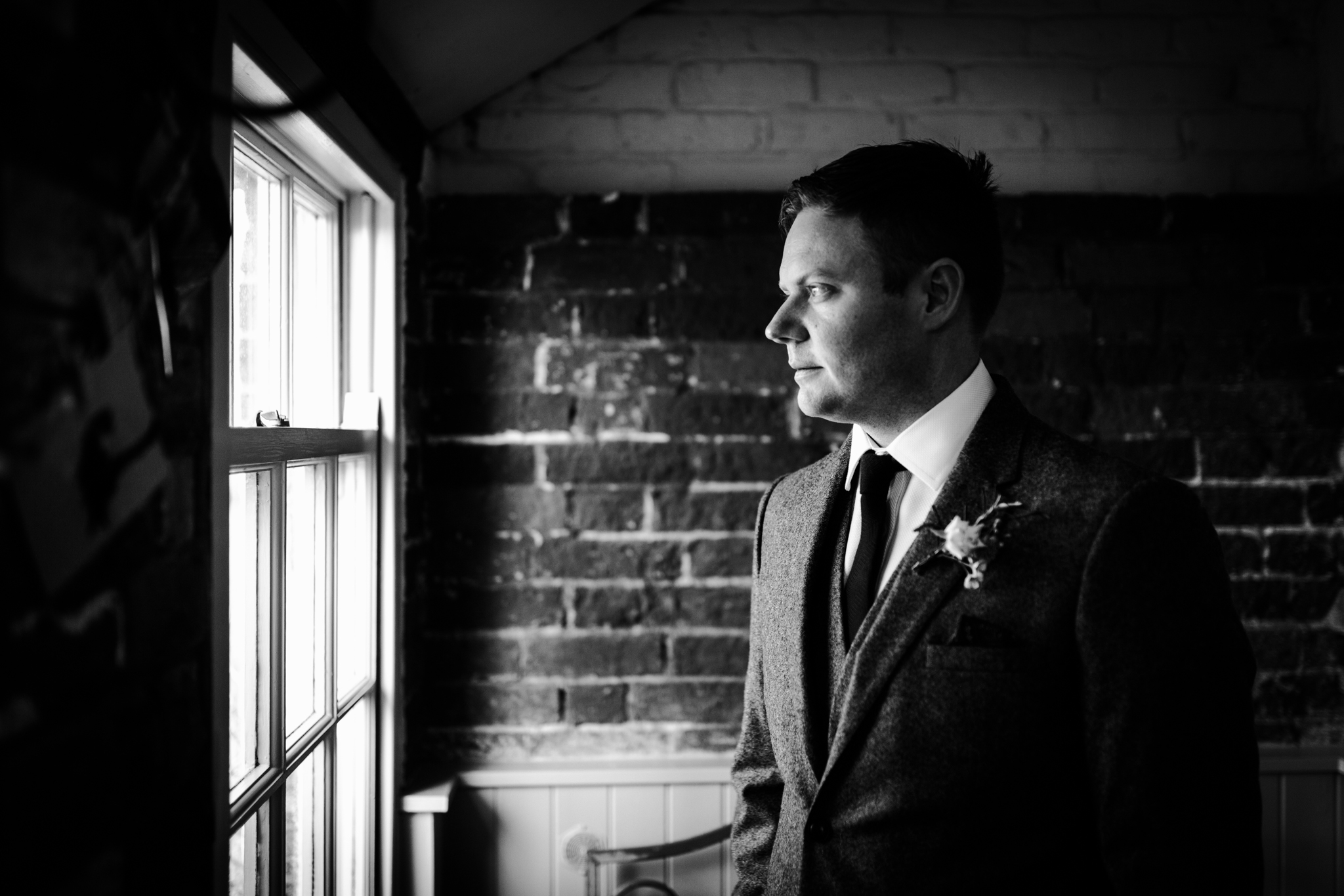 Groom gazing out the window 