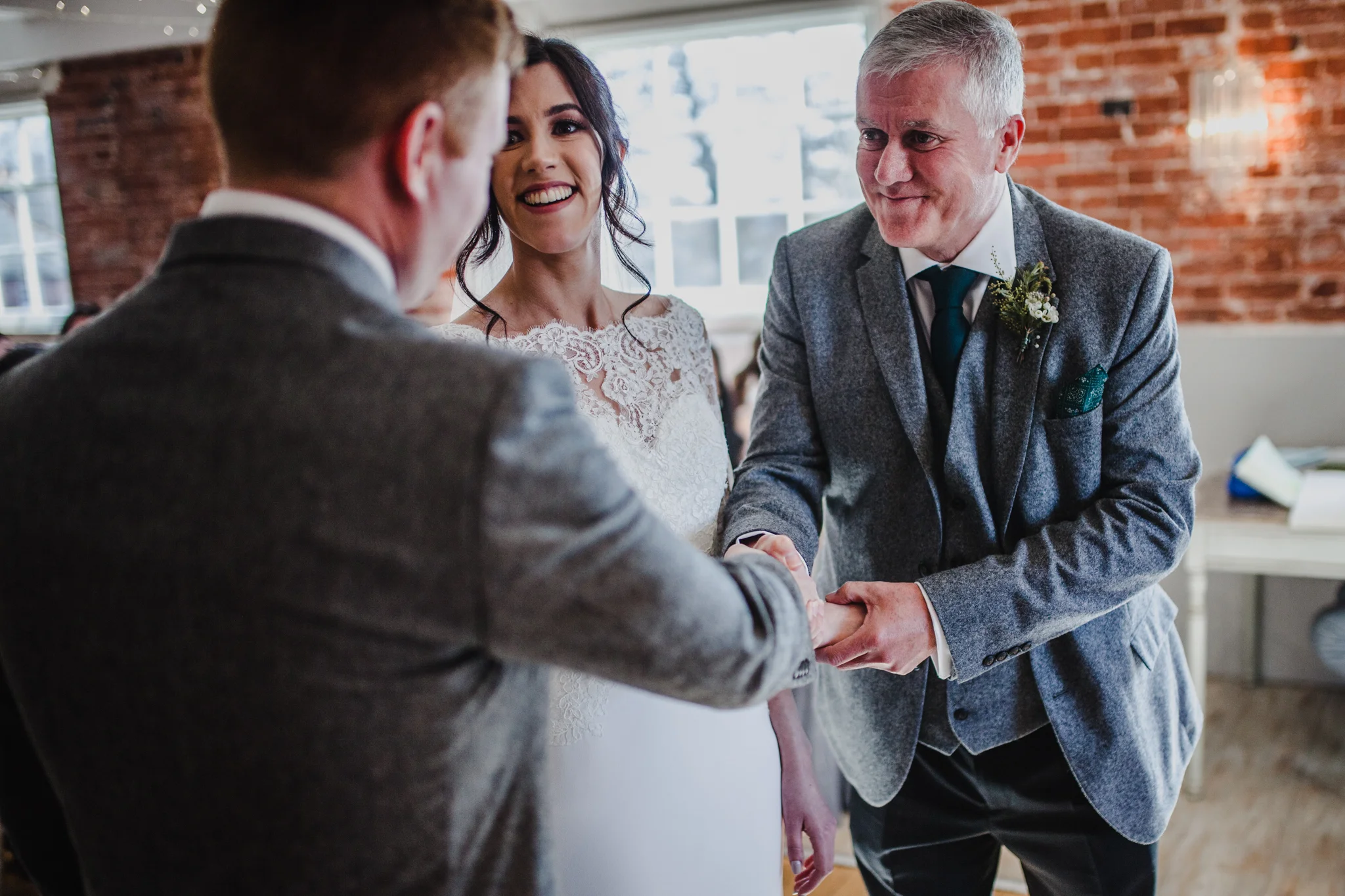 Father of the bride handing his daughter to her future husband
