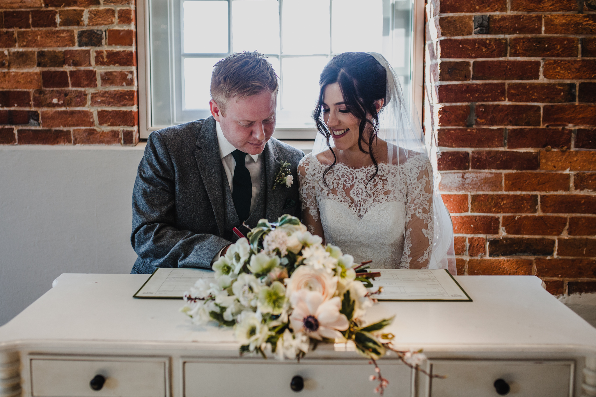 bride and groom signing register