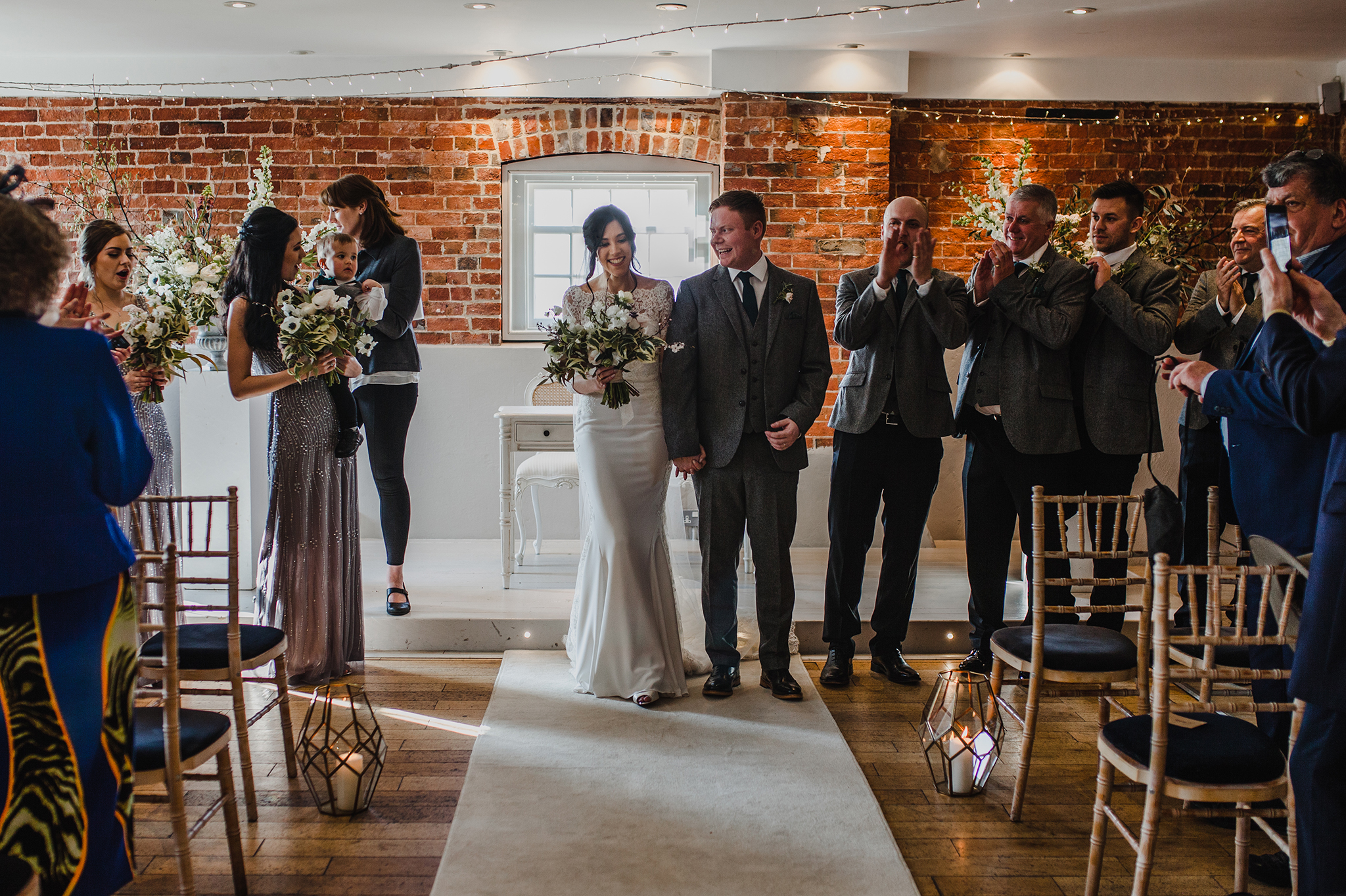 wide view of wedding room with bridal party