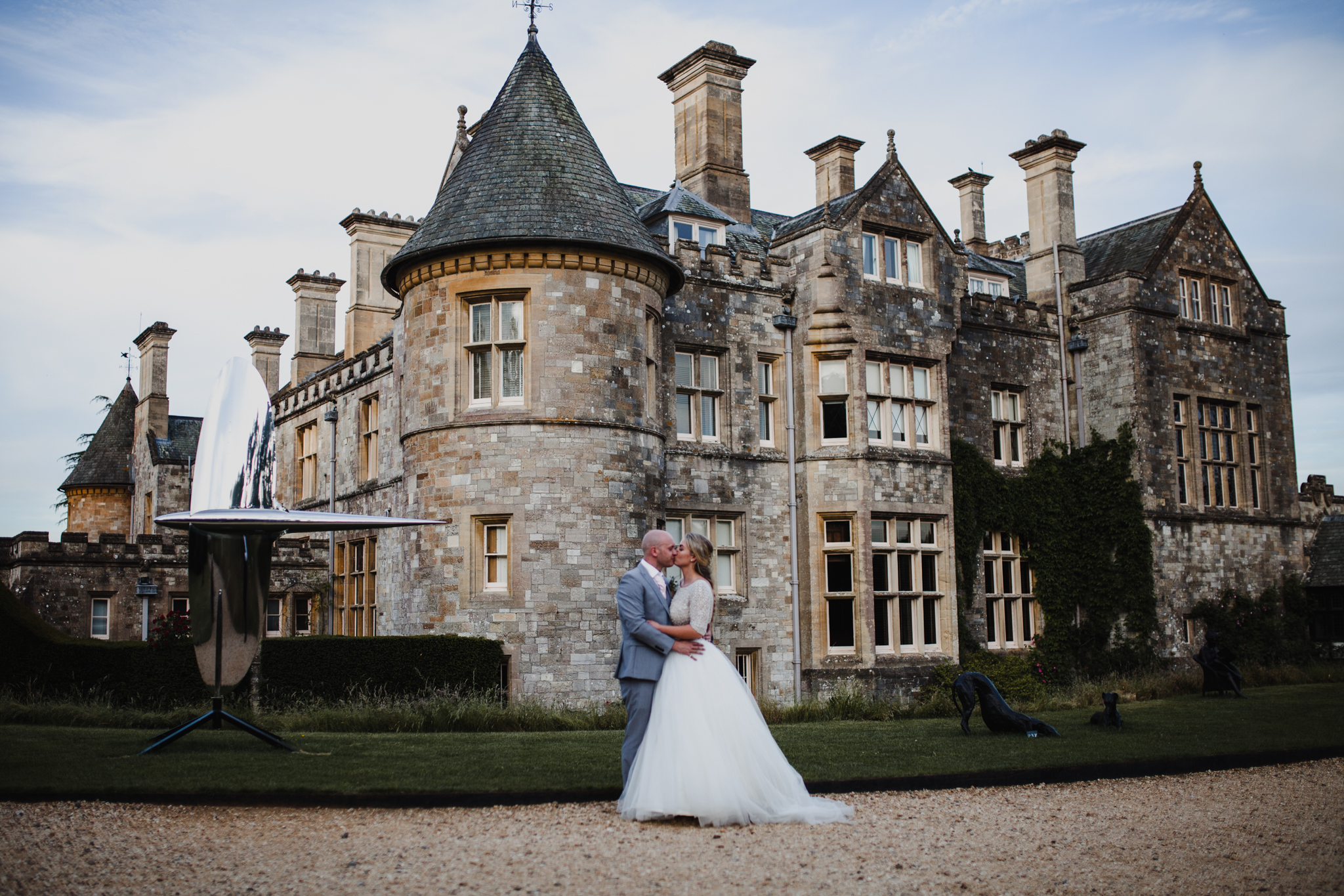English castle with bride and groom kissing