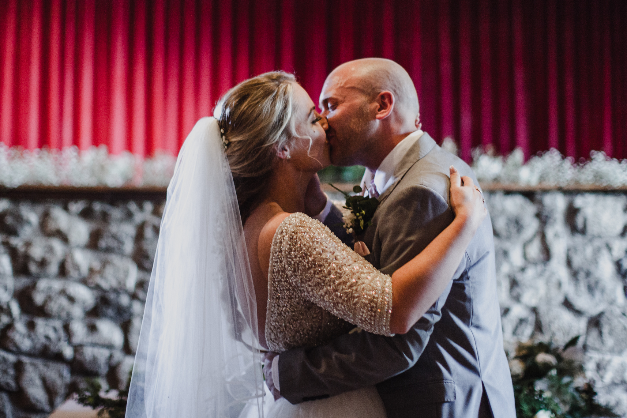 Bride and groom kissing during wedding ceremony