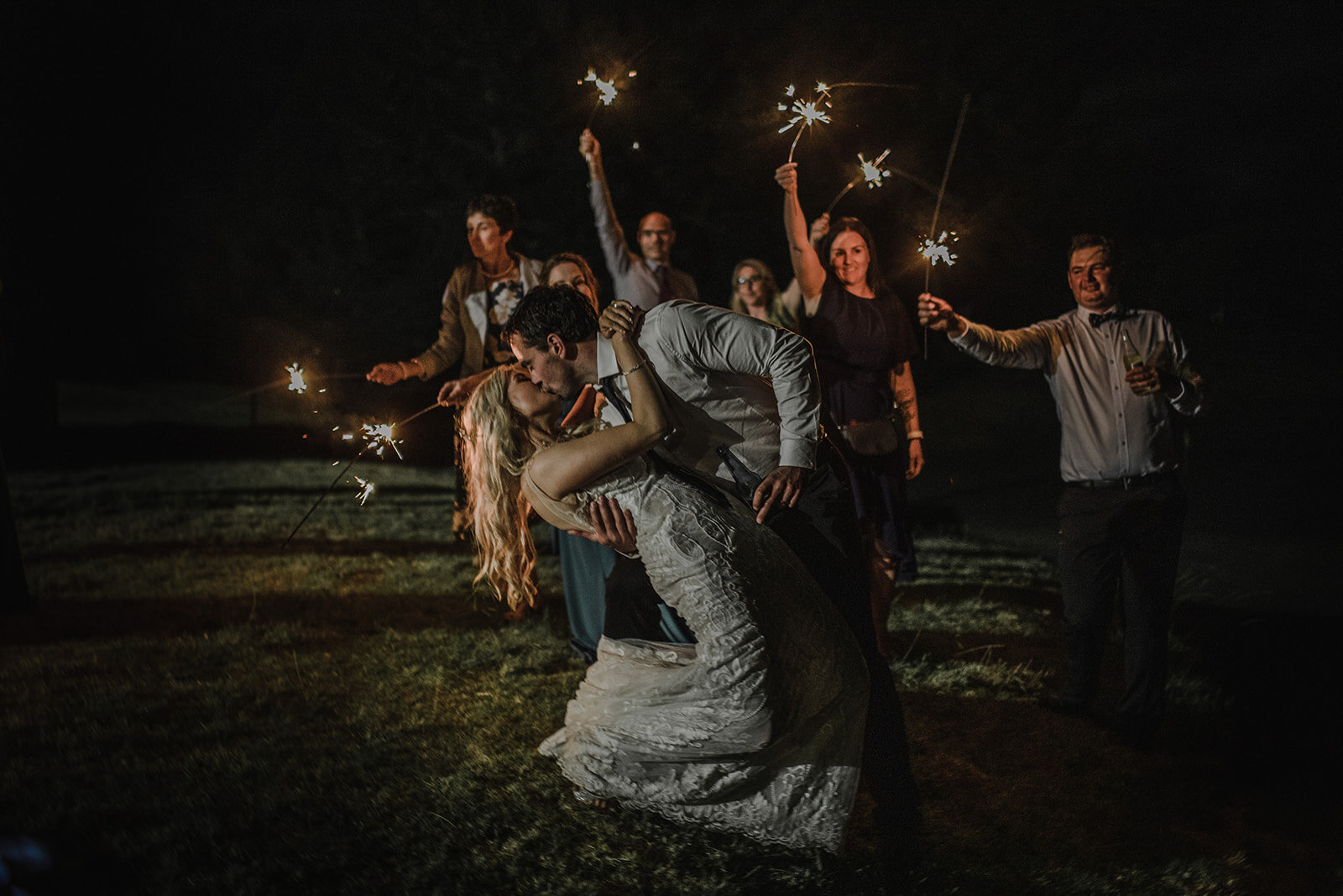 Group wedding shot with sparkles at a back garden wedding