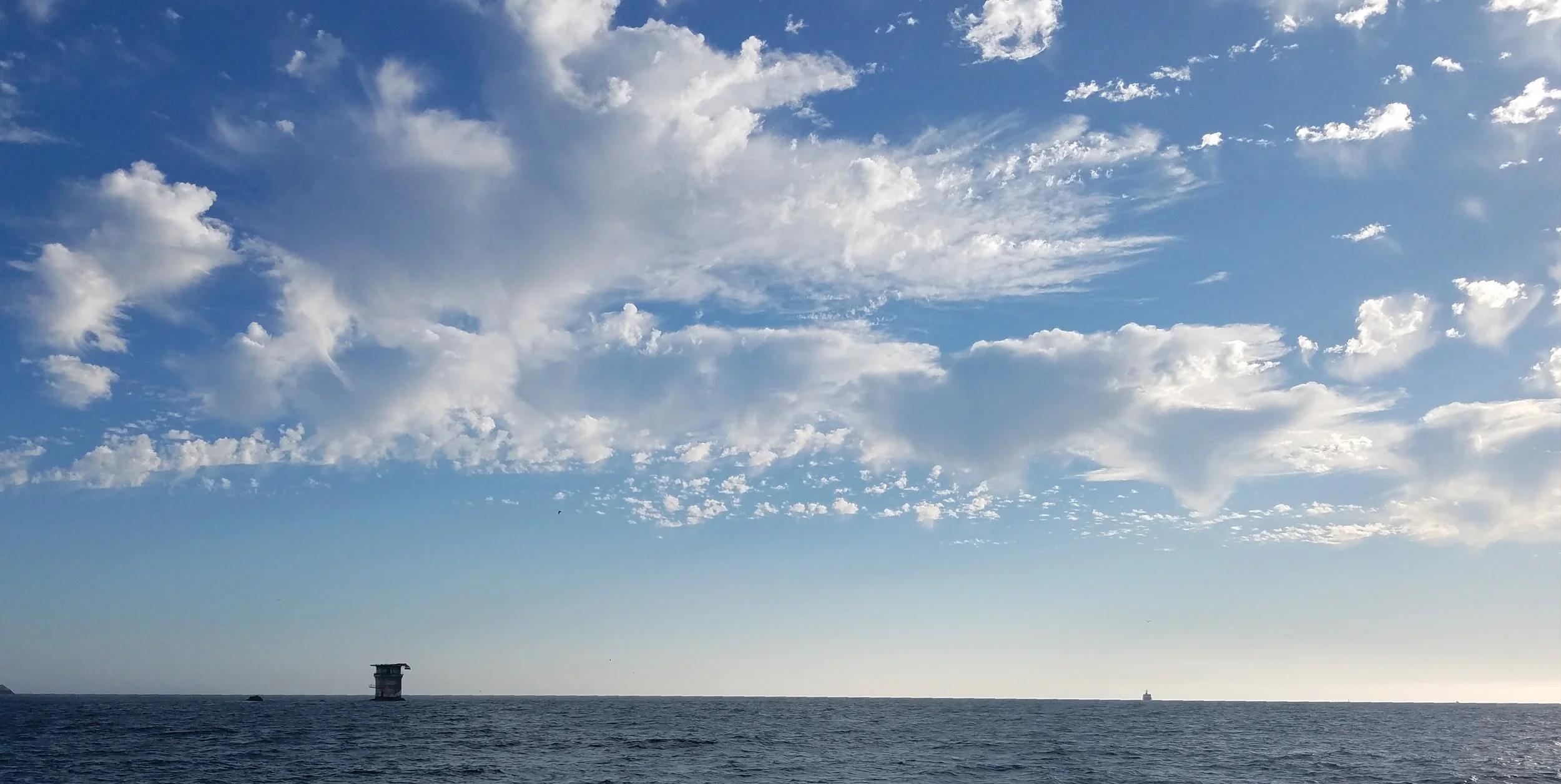 Beautiful weather beyond the bridge, with Mile Rock in the distance. Photo by me. 