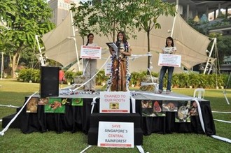 Vilma (left) and Teresa Teo tied themselves to a tree at Hong Lim Park to appeal to LTA to re-route the proposed Cross Island MRT Line. credit: Marcus Chua | Yahoo Newsroom