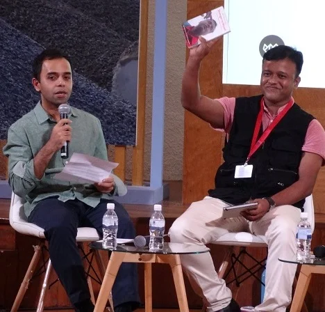 Shivaji Das (left) explores migrant workers' issues at the Speaking for the Voiceless panel that included Bangladeshi construction safety supervisor Mohd Sharif Uddin (right). He is pictured here holding out his newly published Stranger to Myself . Pic by Gaia Discovery.