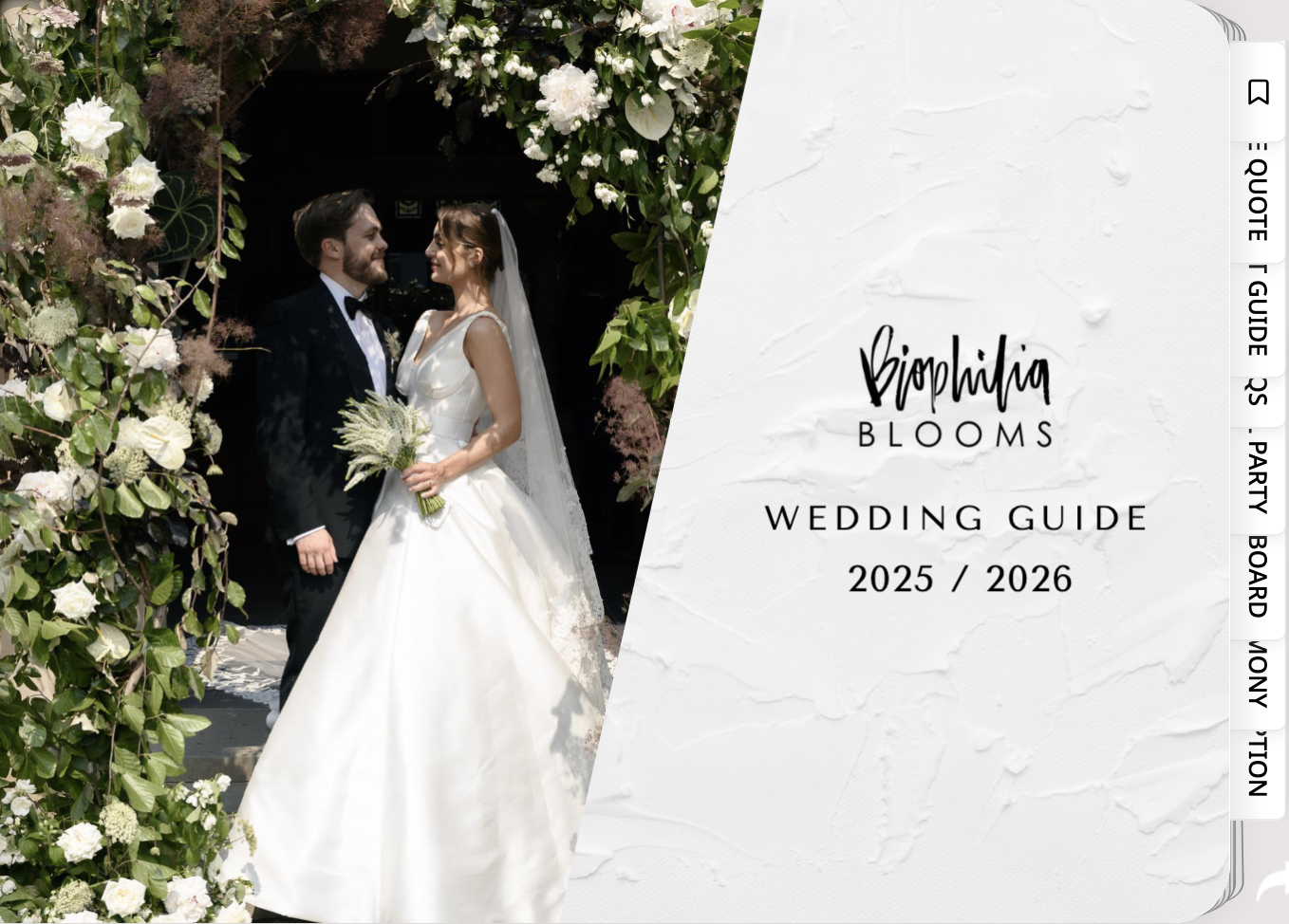 A bride and groom in wedding attire standing outdoors, surrounded by lush white and green floral arrangements, with a wedding guide overlay on the right side that says "Biophilia Blooms Wedding Guide 2025/2026."