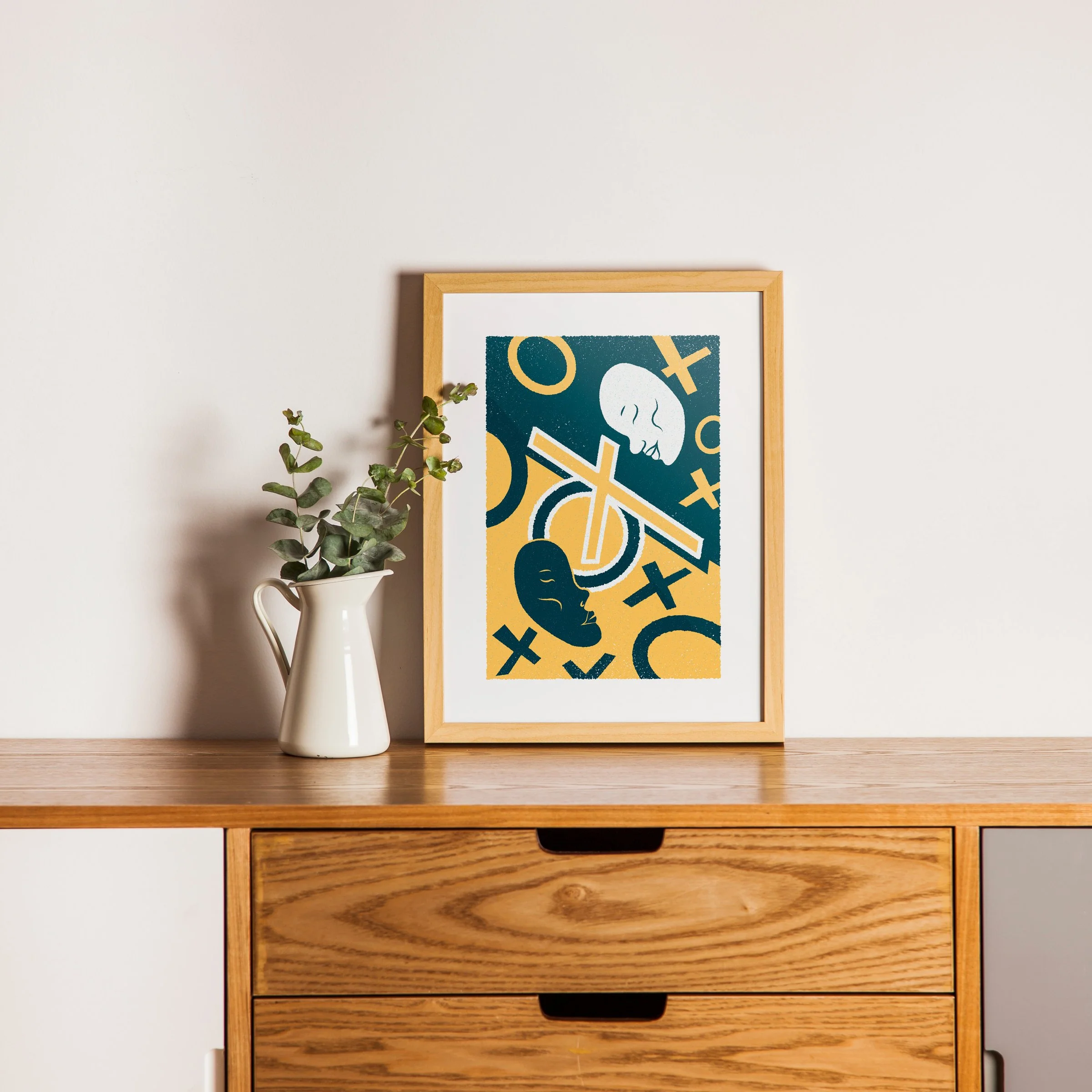 The Dividing Line - Two Faces Art Print, shown in a oak frame above an oak cabinet. Print supplied unframed.