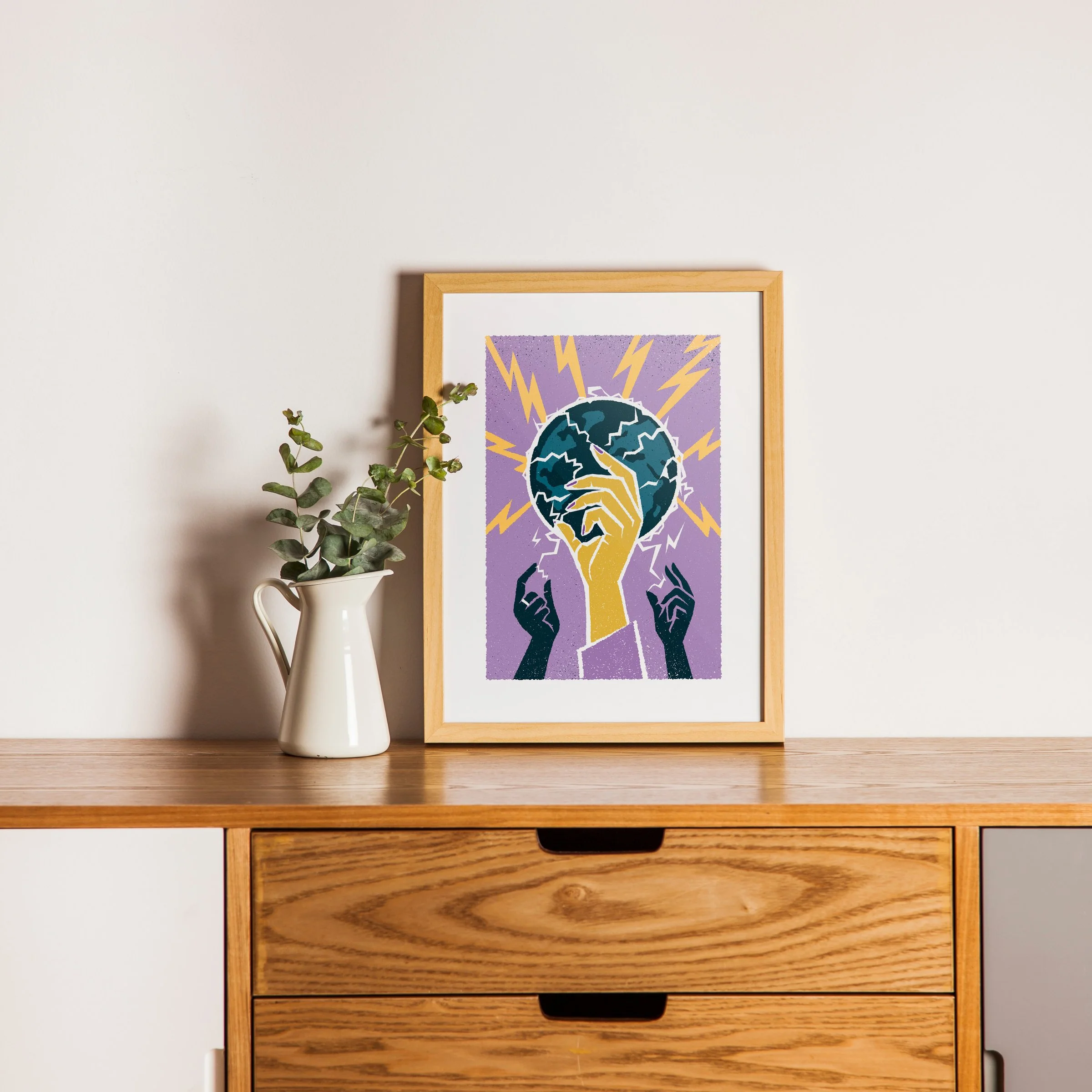 Who Holds It Now - Lightning & Globe Art Print, shown in a oak frame above an oak cabinet. Print supplied unframed.