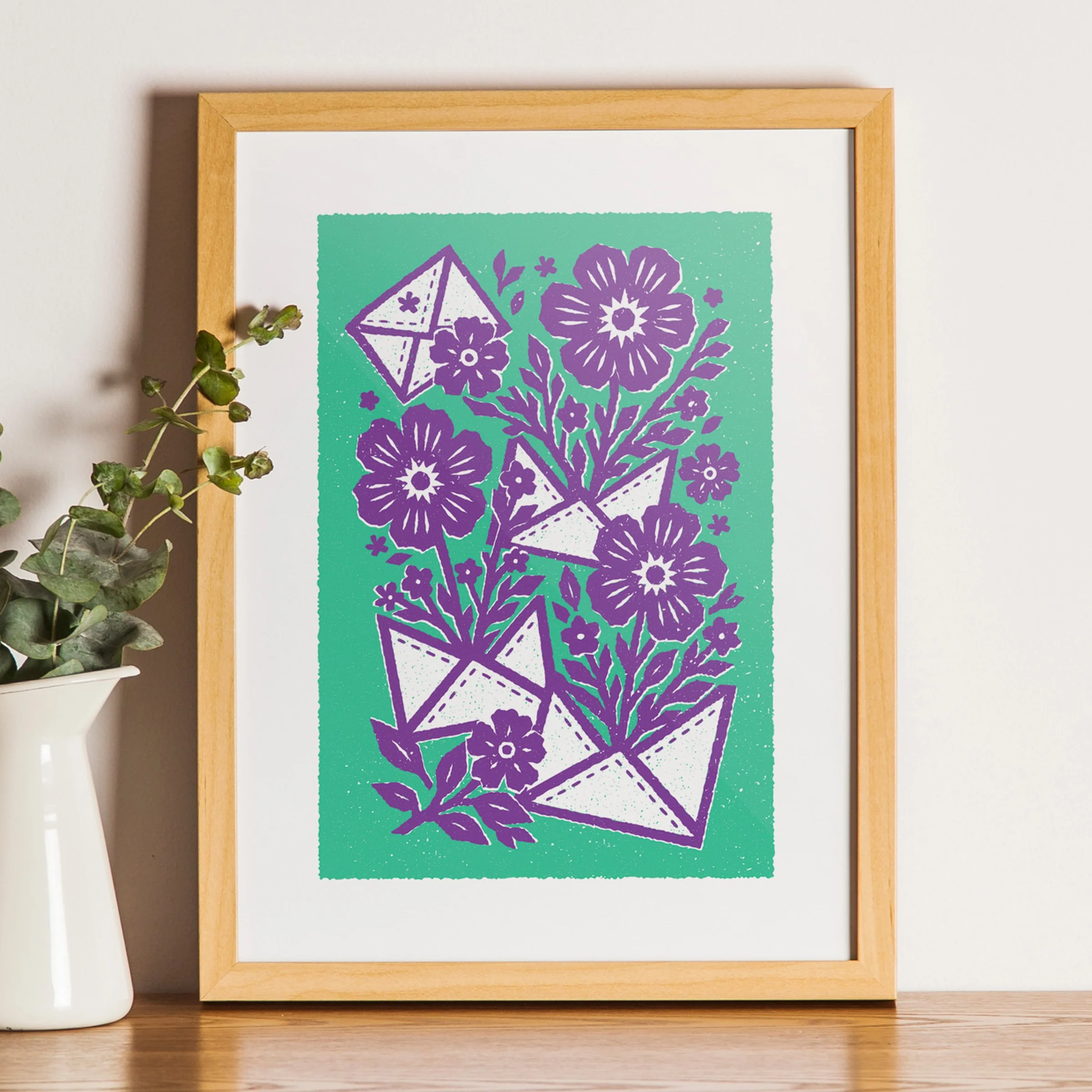 A Colour Worth Noticing - Flowers & Letters Art Print, shown in a oak frame above an oak cabinet. Print supplied unframed.