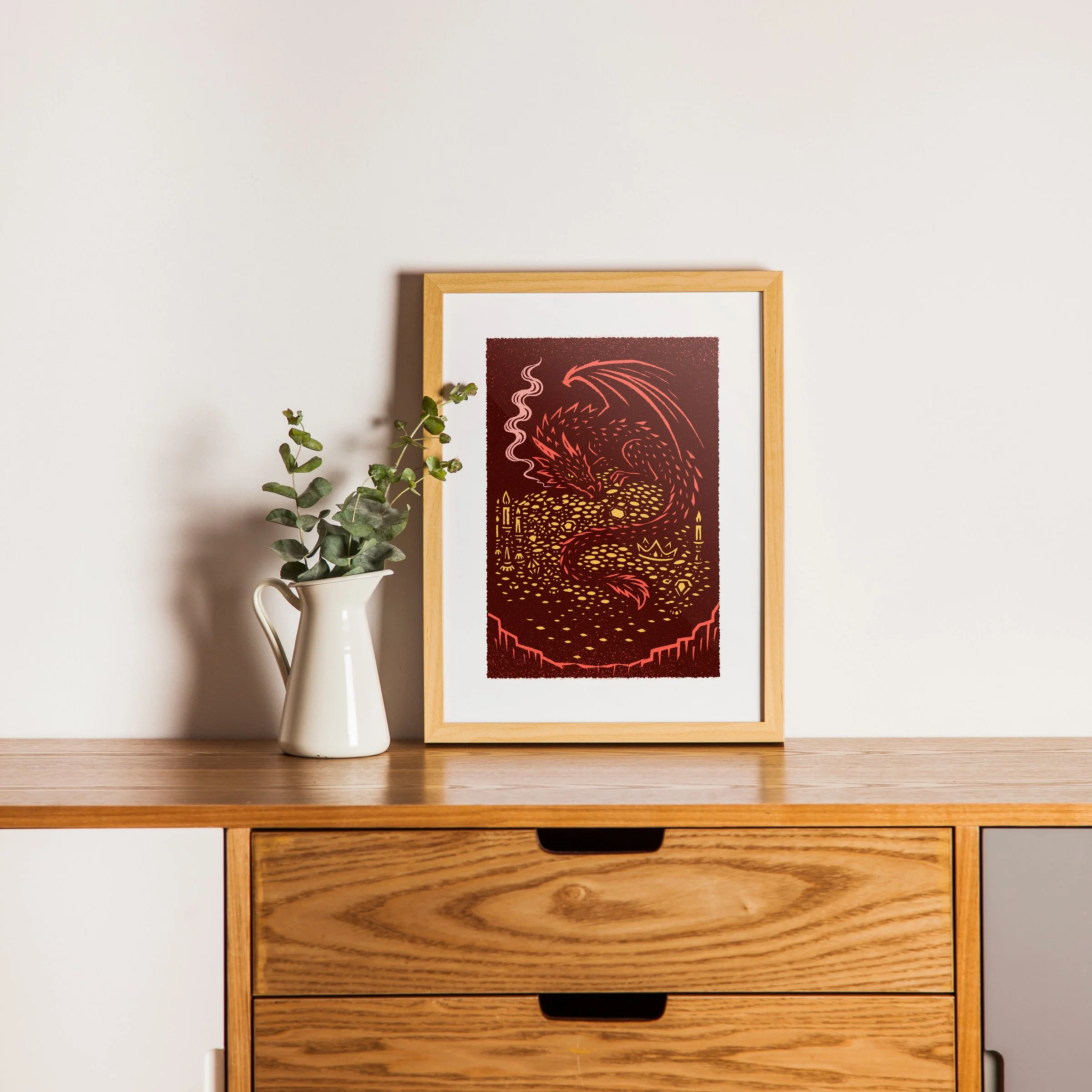 The Hoard - Dragon Art Print, shown in a oak frame above an oak cabinet. Print supplied unframed.