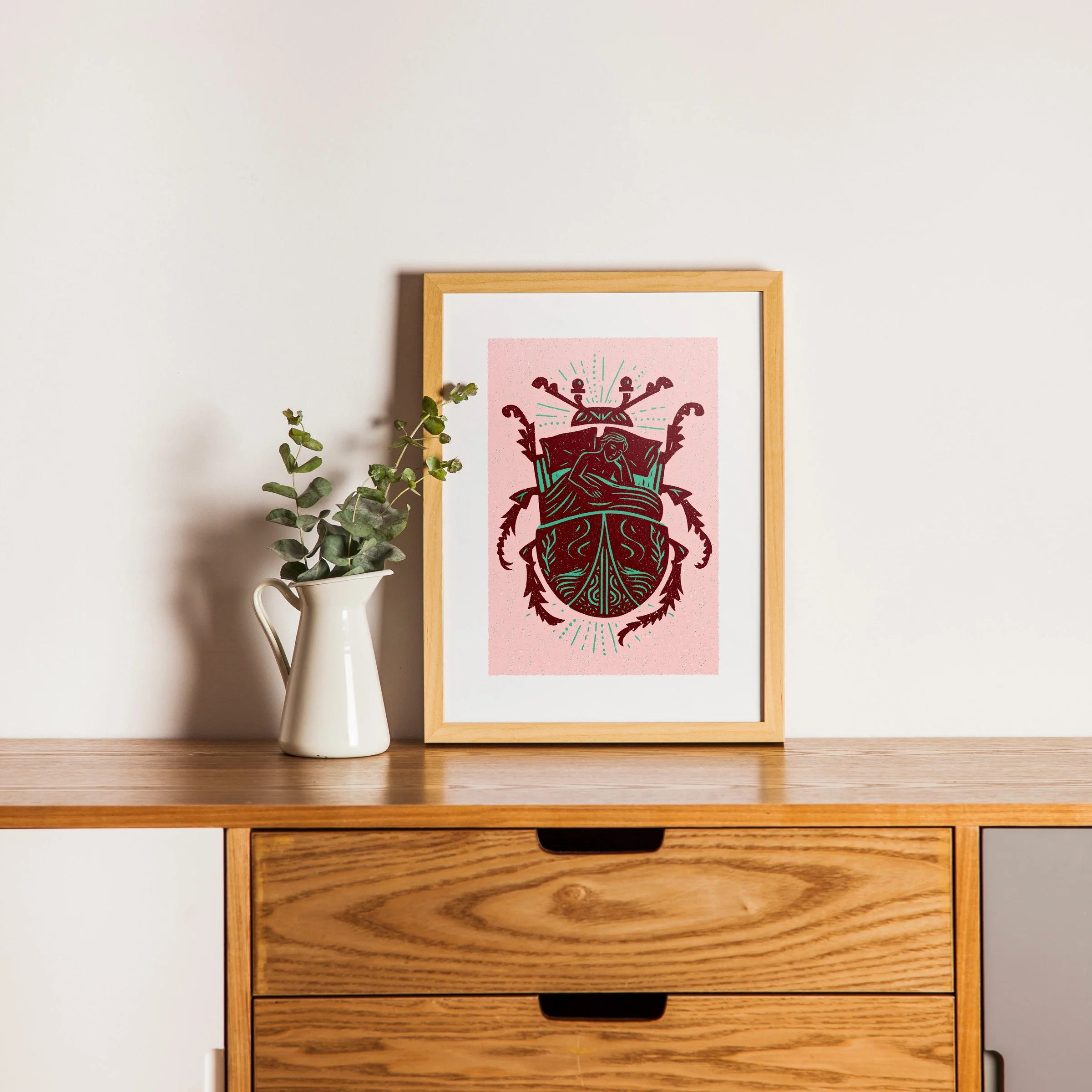 Waking Changed - Metamorphosis Beetle Art Print, shown in a oak frame above an oak cabinet. Print supplied unframed.