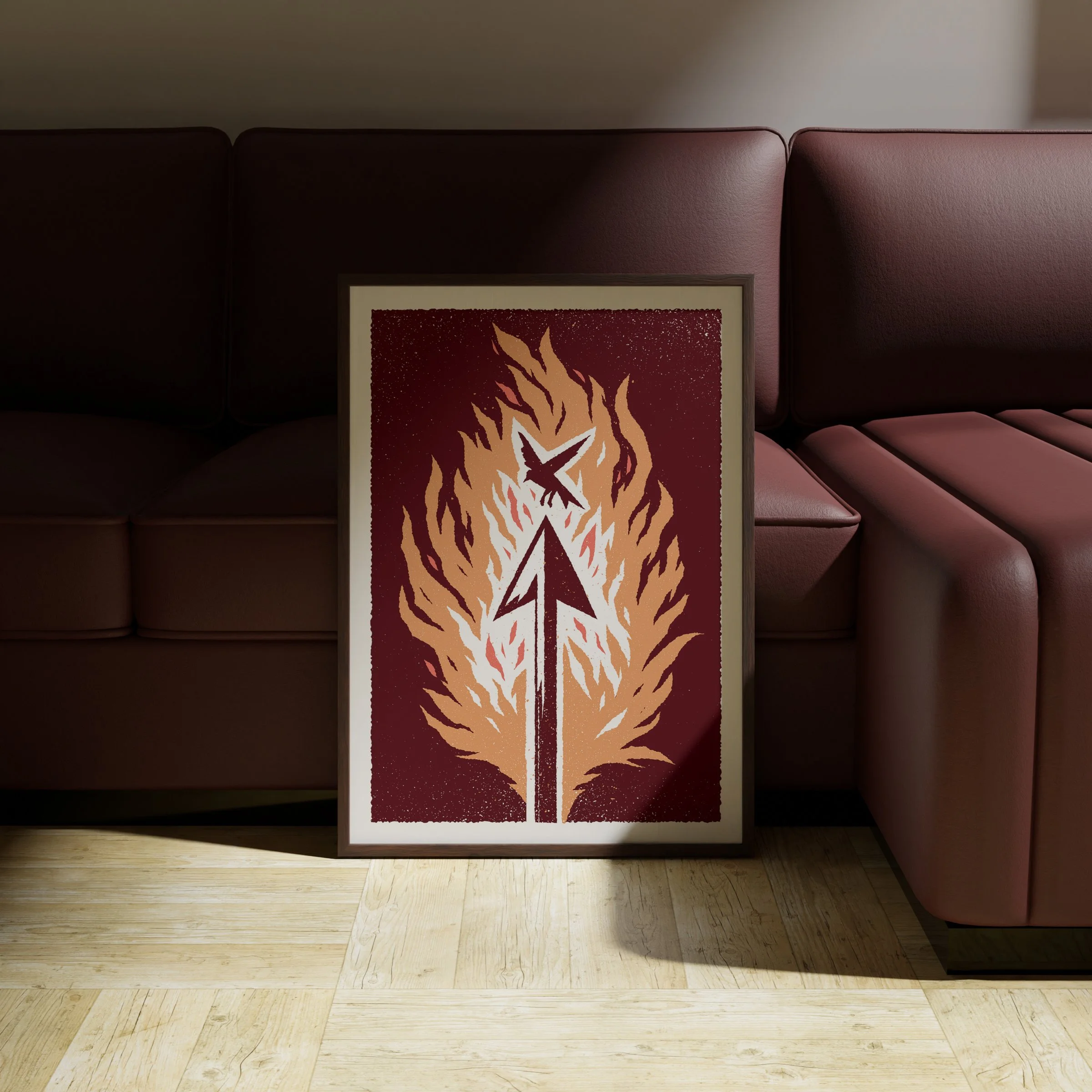 The Shot That Matters - Flaming Arrow Art Print, shown in a dark frame above a warm sofa. Print supplied unframed.