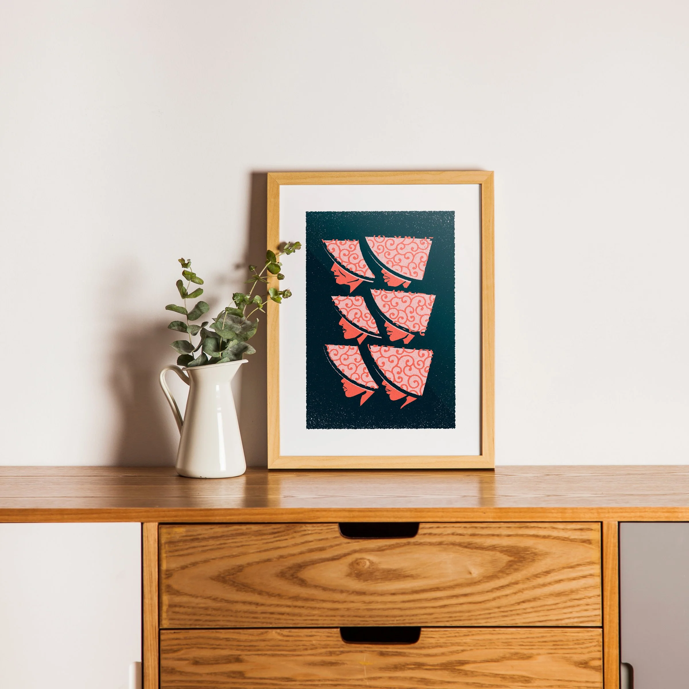 What Is Taken Away - Repeating Profiles Art Print, shown in a oak frame above an oak cabinet. Print supplied unframed.