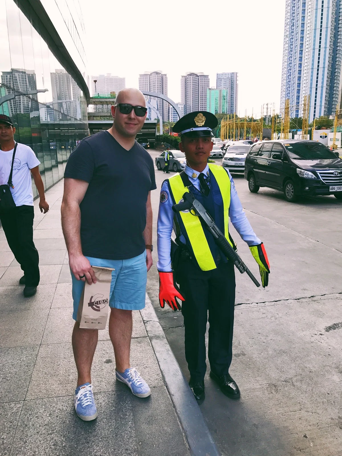 Here's a picture of me (*not Vin Diesel) with the SM Aura mall security guard carrying a rifle.