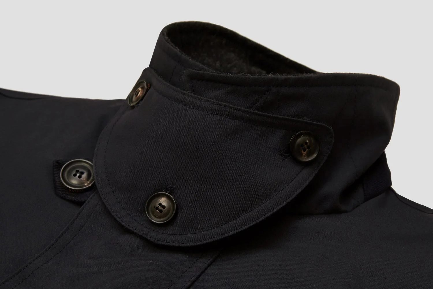 Neck sealed by signature three-button storm baffle.