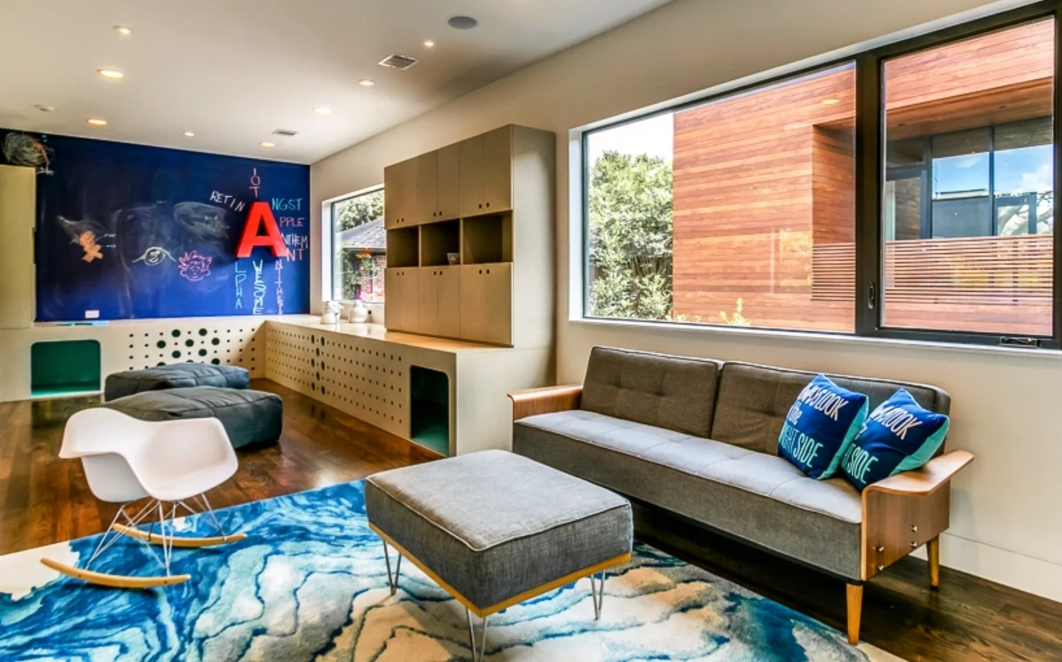 built-ins. Cabinets and play tunnel in upstairs flex room represent ample built-in storage and furniture to reduce clutter and maintain clean lines.