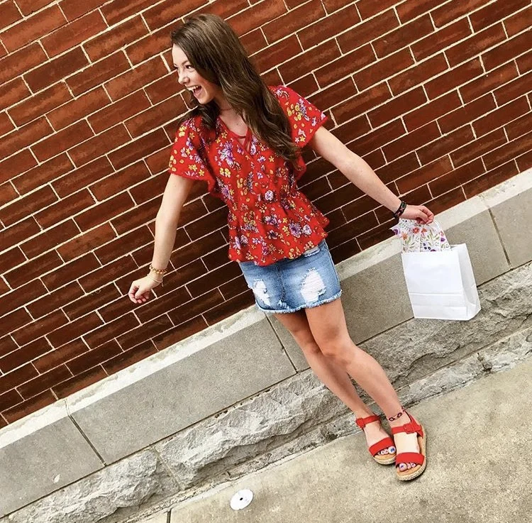 MARSHALLS SHIRT has a cinched waist, with a 70s floral print and crisscrosses at the chest DENIM SKIRT from a local boutique, Logo N Stitch RED PLATFORMS are from designer Kenneth Cole at Dillard's 