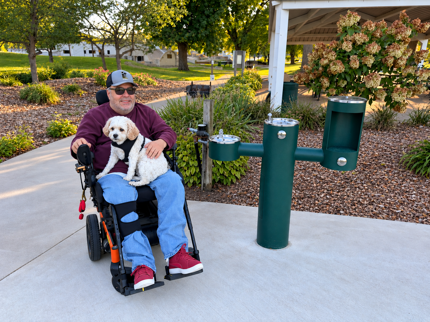 Man using a wheelchair next to an accessible fountain