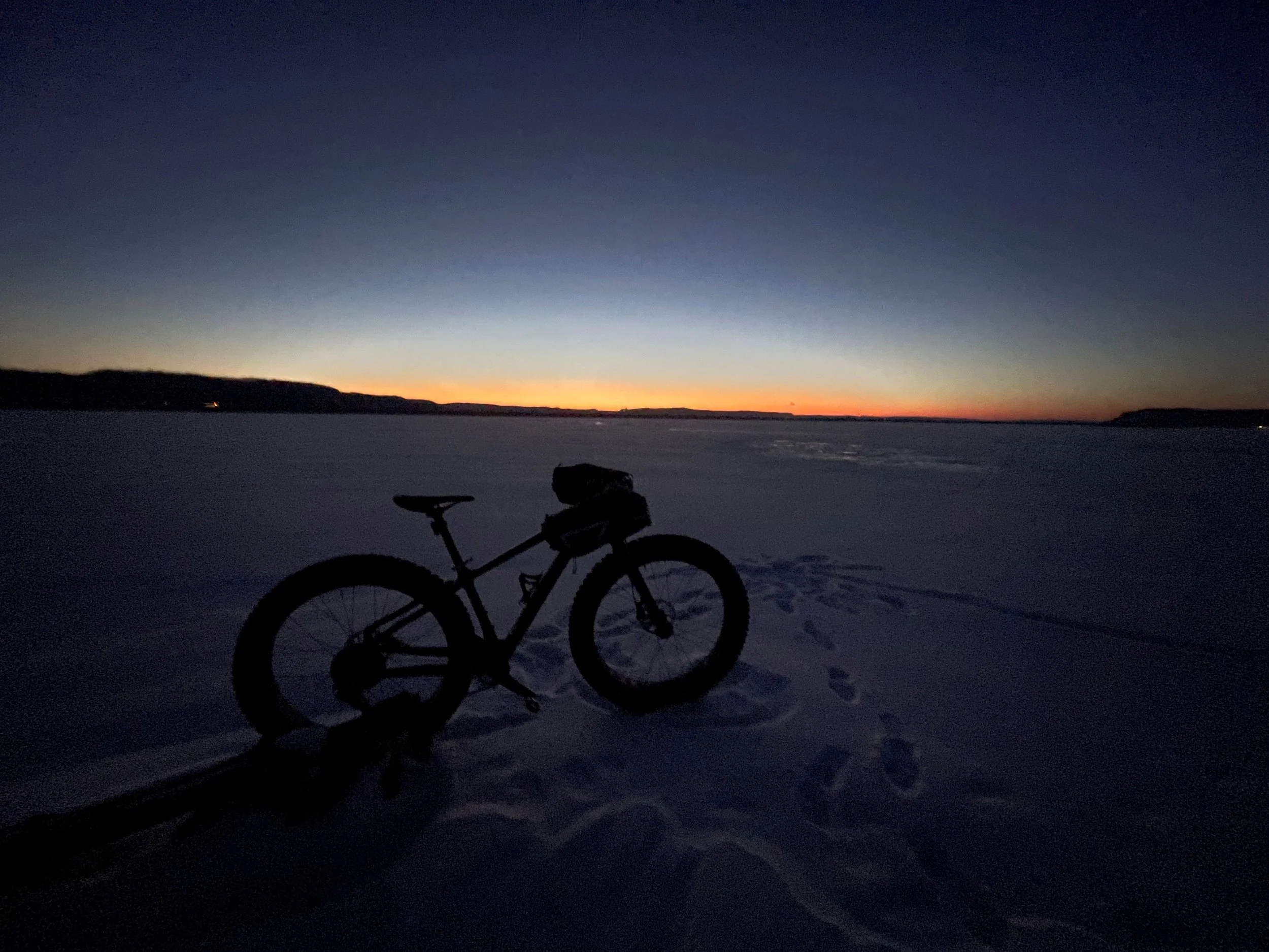 Fat bike in the snow with handlebar mittens or pogies.
