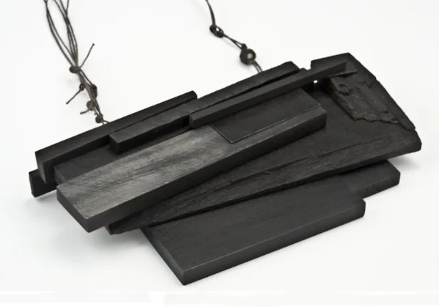 above necklace: Black Pile, wood, paint, steel, gray string