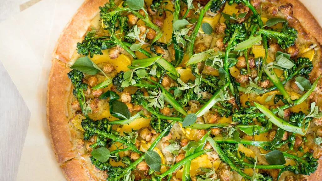 Winter Squash Pizza with herbed cream sauce, delicata squash, hickory smoked chickpea, broccoli rabe and fresh oregano.