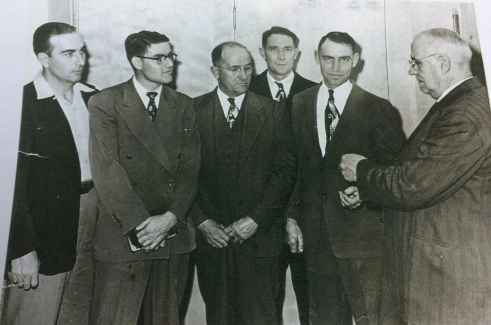 After the construction of our present church building, the contractor handed the key to Garnett Hinton, Allen Hinton, Thurman Stevens, Fred Harmon (pastor), and Melvin Staggs.