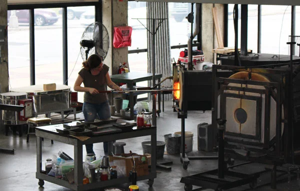 Glass artist firing work in the Flame Run Studio