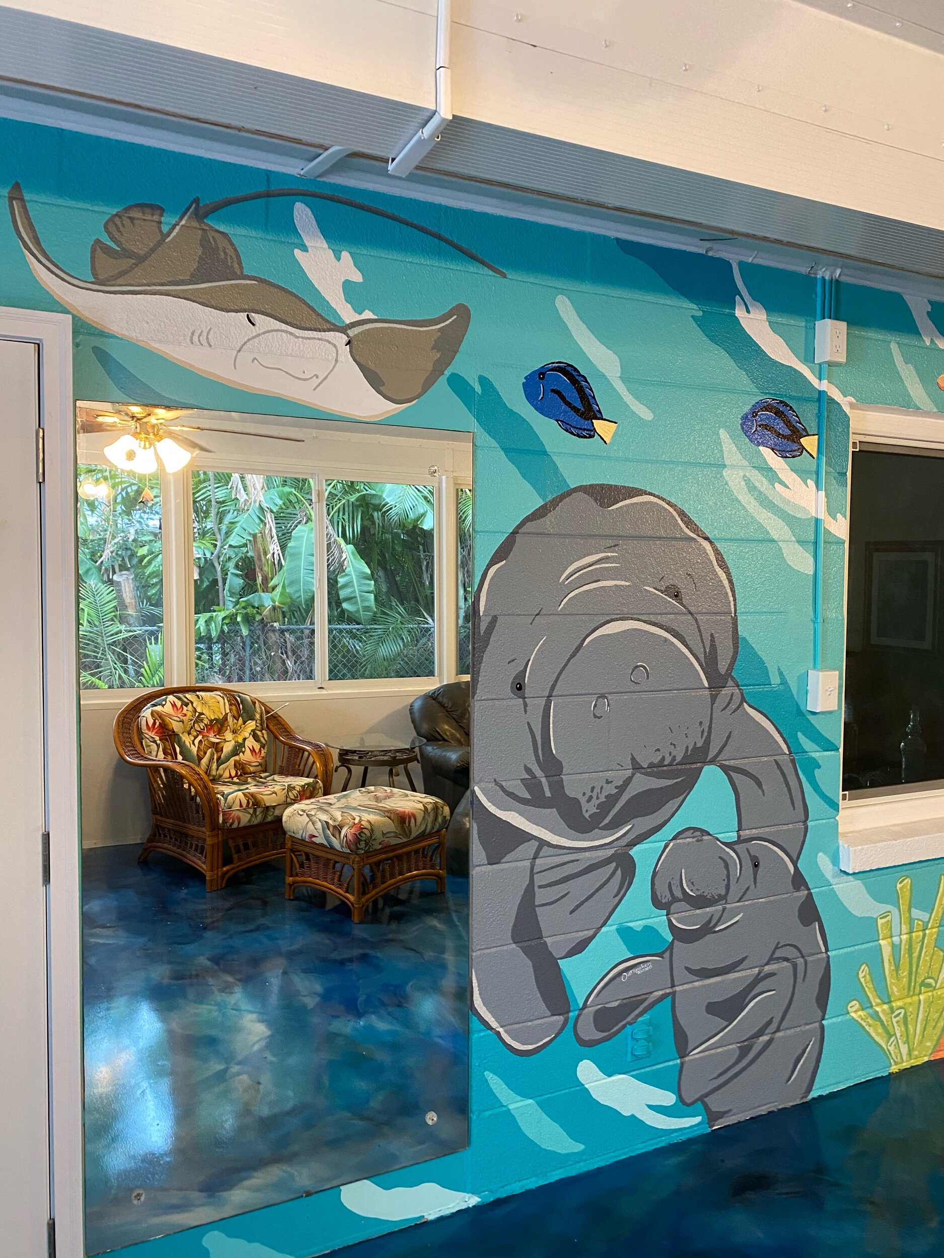 Ocean mural of manatees and stingray 