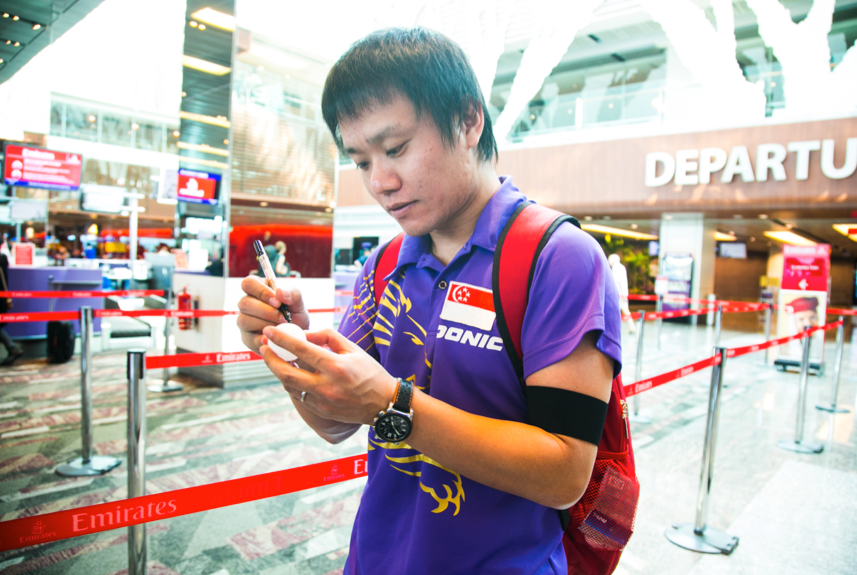 Ouroboros (a member of the Singapore Table Tennis Association writing a message on a ping pong ball), Nicola Anthony, 2015