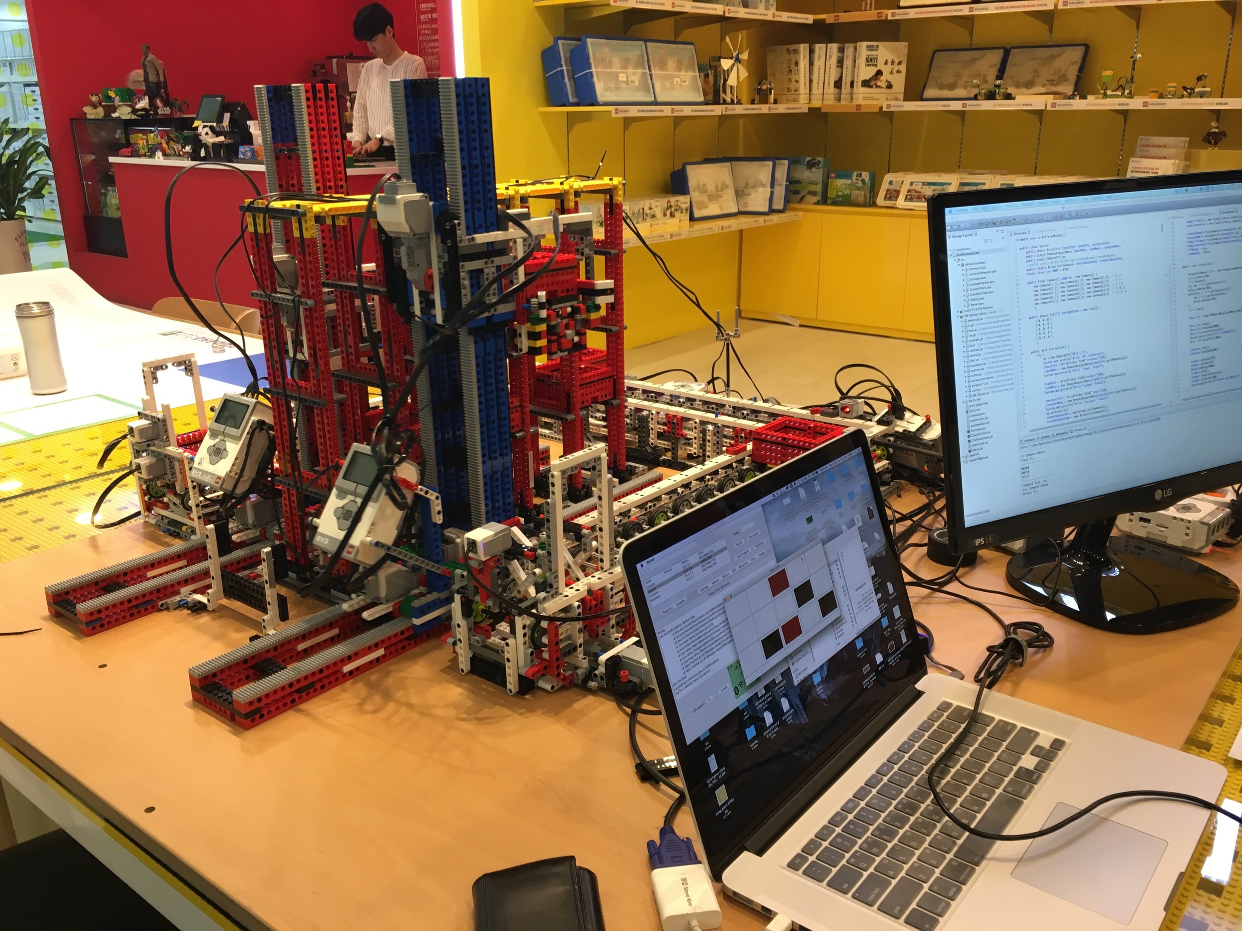 The AutoFactory model in Command Mode. Note the real-time box storage tracker on the MacBook screen.