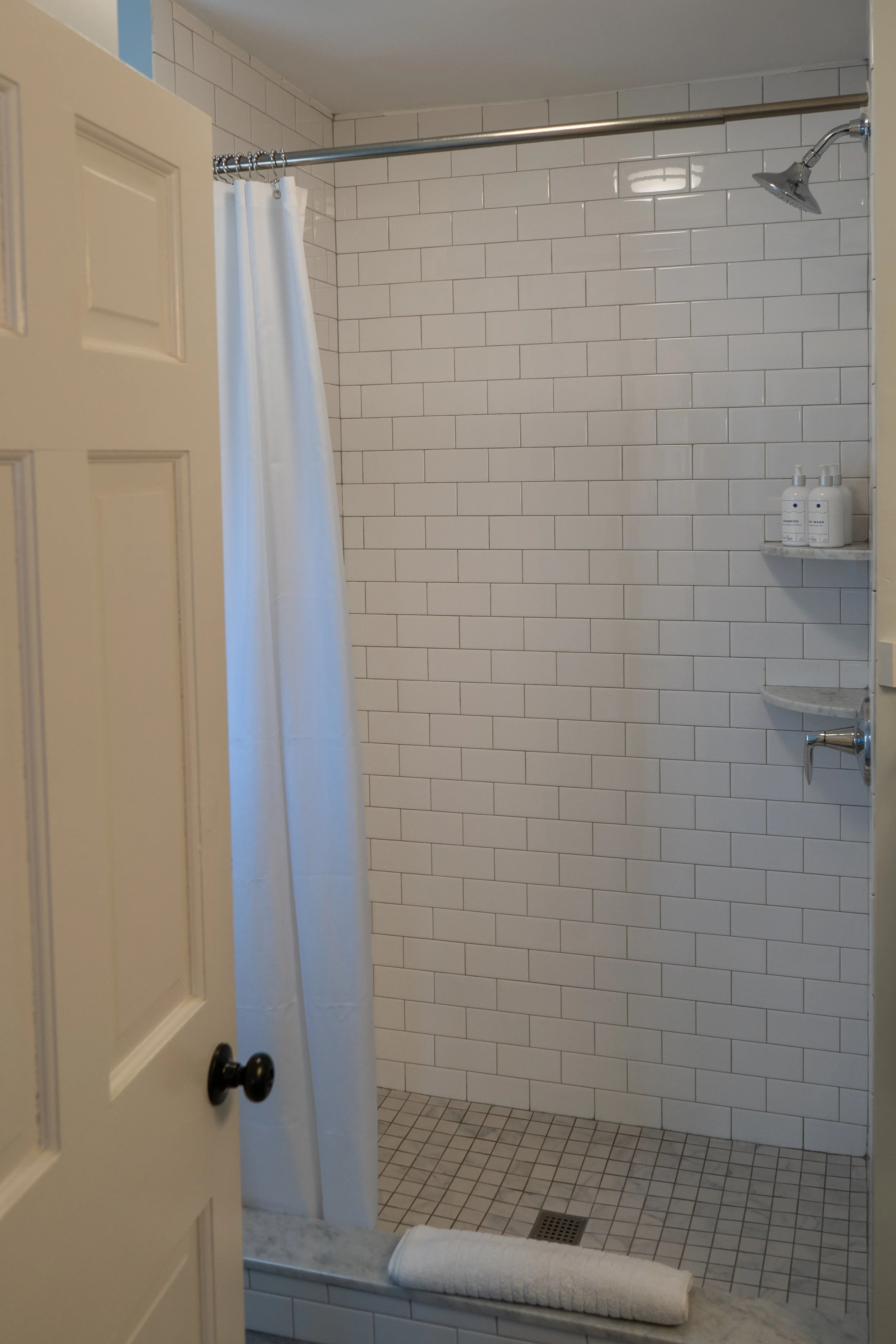Walk-in tiled shower in Room 5 at The Sailmaker’s House with white subway tile