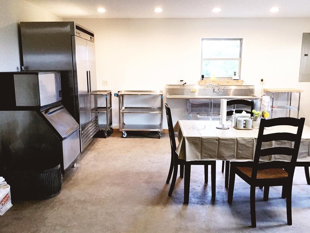  The Kitchen - equipped with a large refrigerator, ice-maker, sink, foodservice carts, and more. 