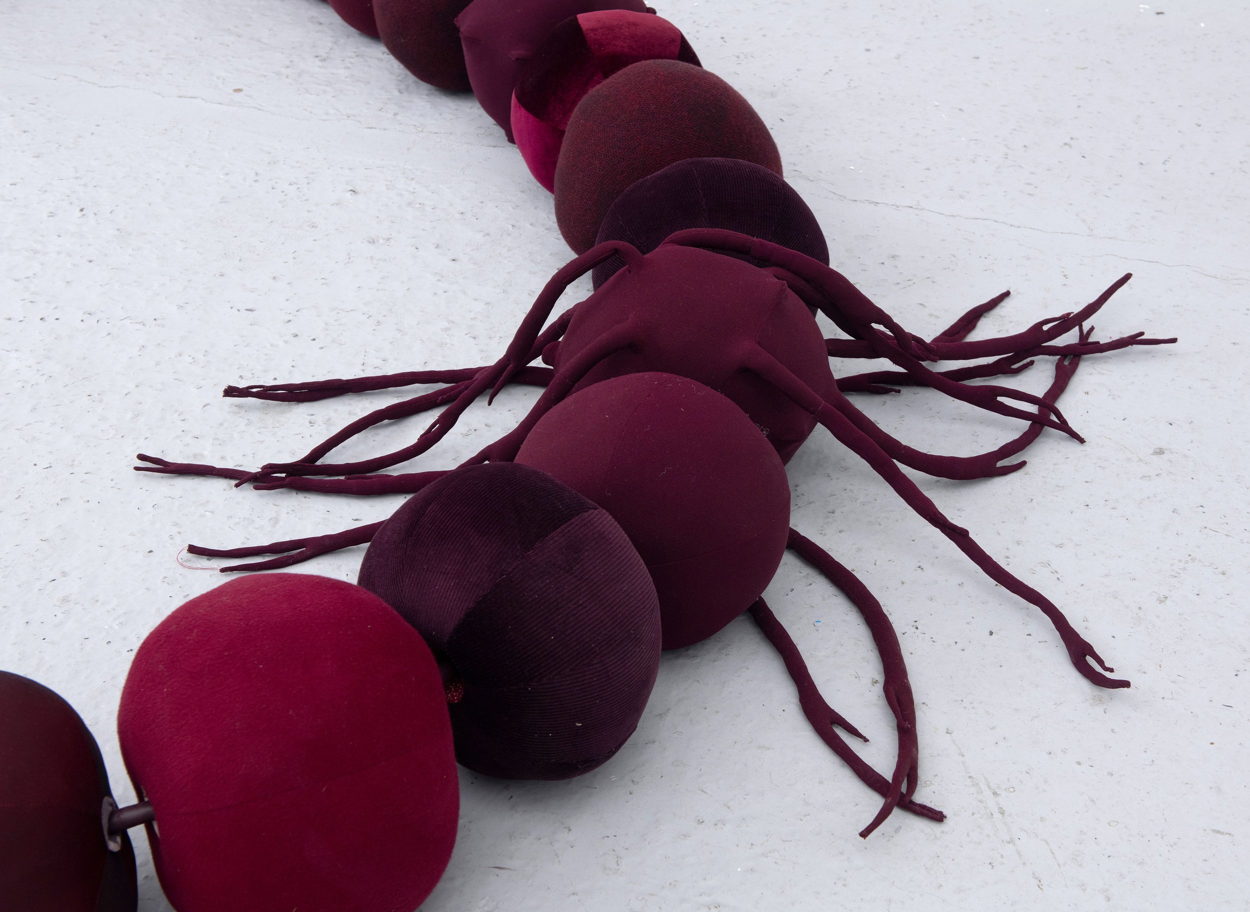   Beadwork: dealing with the leavings , 2025, detail shot  49 repurposed hollow fibre filled fabric beads, vinyl and shimmer satin cord, metal hook and screws; Approx 2 x 2 x 2.5m. Image credit: Justin Piperger 