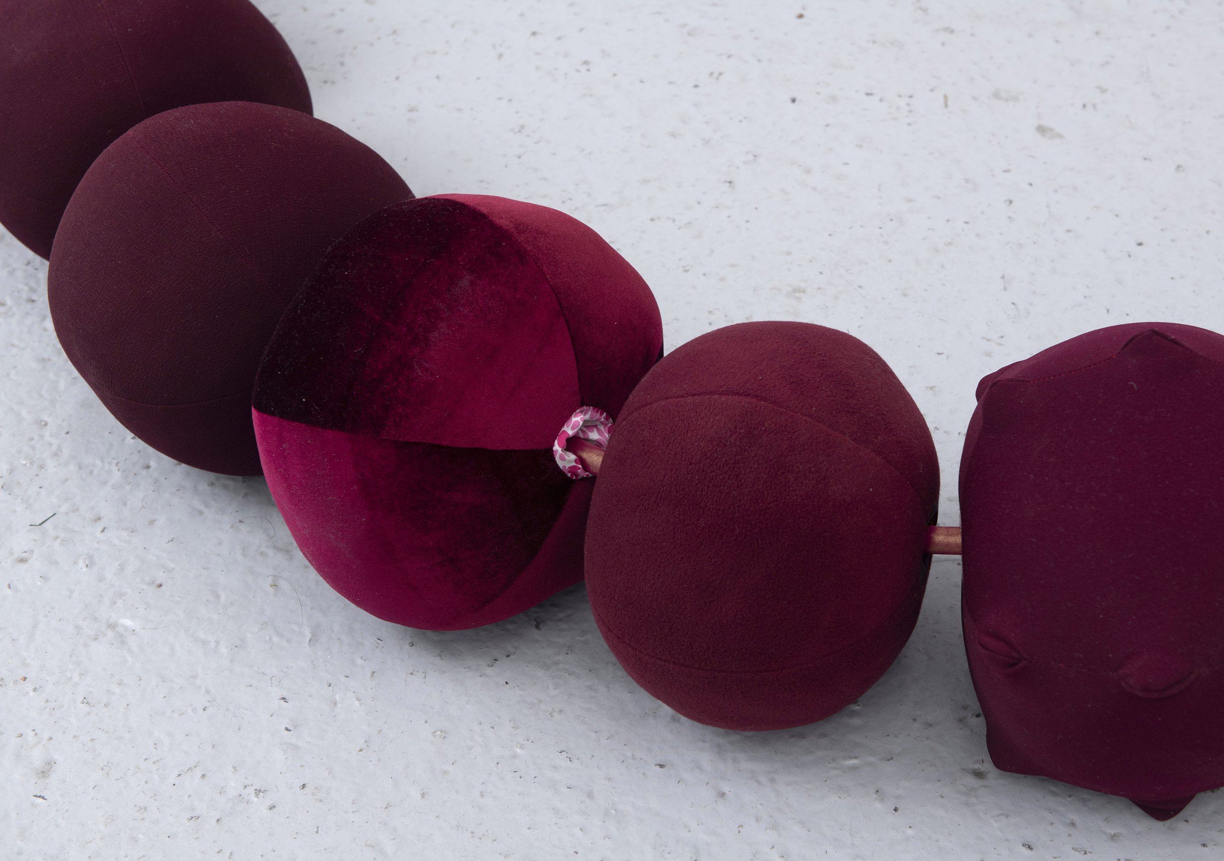   Beadwork: dealing with the leavings , 2025, detail shot  49 repurposed hollow fibre filled fabric beads, vinyl and shimmer satin cord, metal hook and screws; Approx 2 x 2 x 2.5m. Image credit: Justin Piperger 