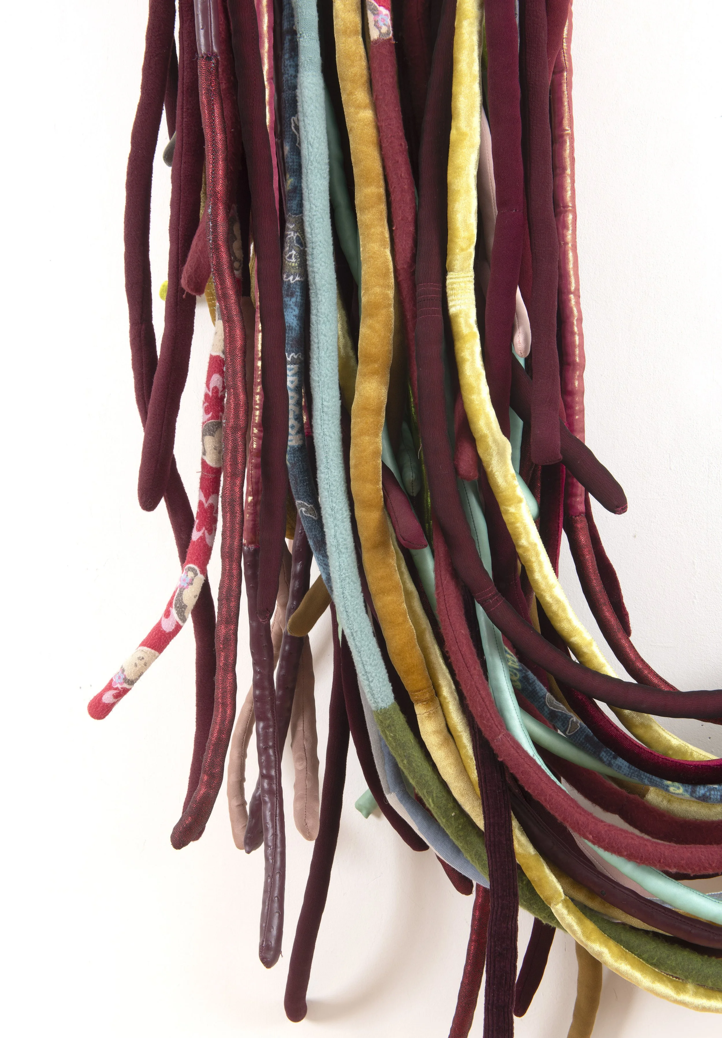  Venous (2), 2024-26   mixed media installation of 41 soft sculptures, wooden wall pegs, approx. 205 x75 x 22 cm, wall mounted. Image credit: Justin Piperger 