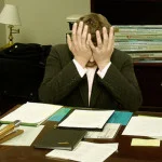 Frustrated_man_at_a_desk_cropped-150x150.jpg