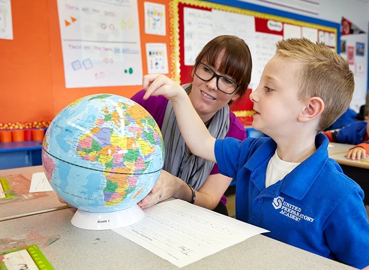 SPI-Photo-003_Student and teacher with a globe_2014_lr.jpg