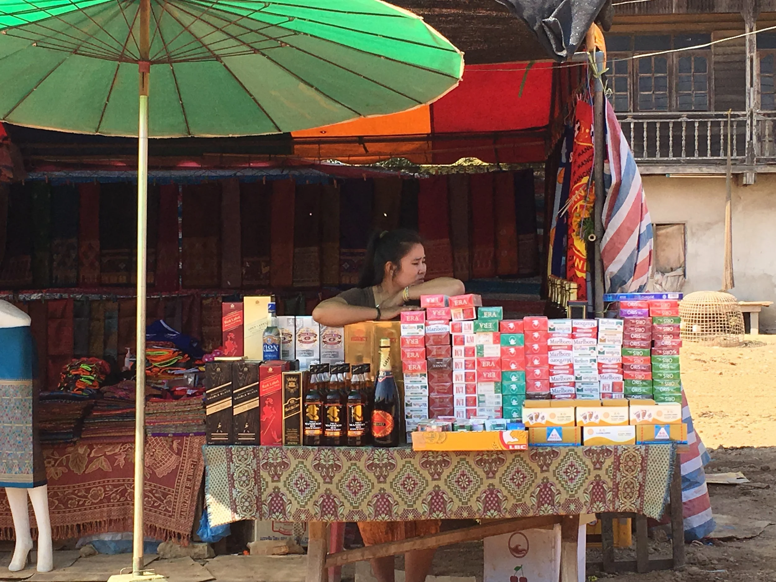 A woman selling liquor and cigarettes in Laos