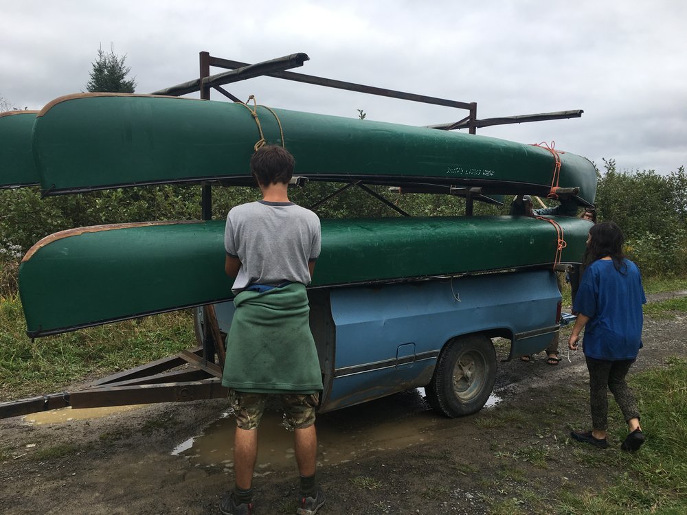 Zander ties down the canoes onto the trailer.