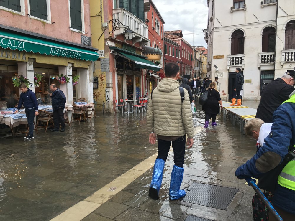 Visitors bought plastic boot covers to walk through the flooded streets of Venice.