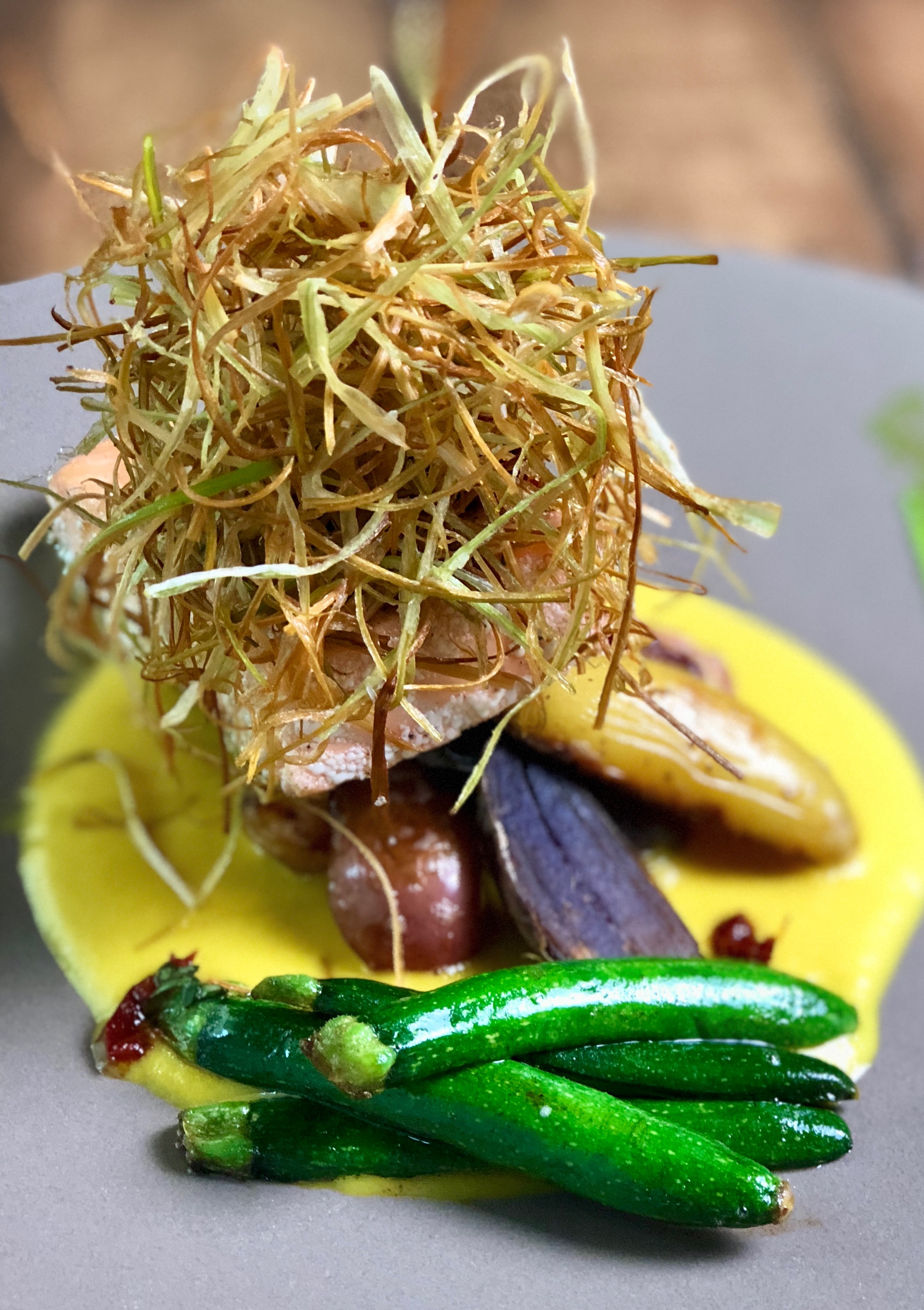 Salmon Confit, Yellow Pepper Saffron Broth, Mediterranean Salad, & Crispy Leeks