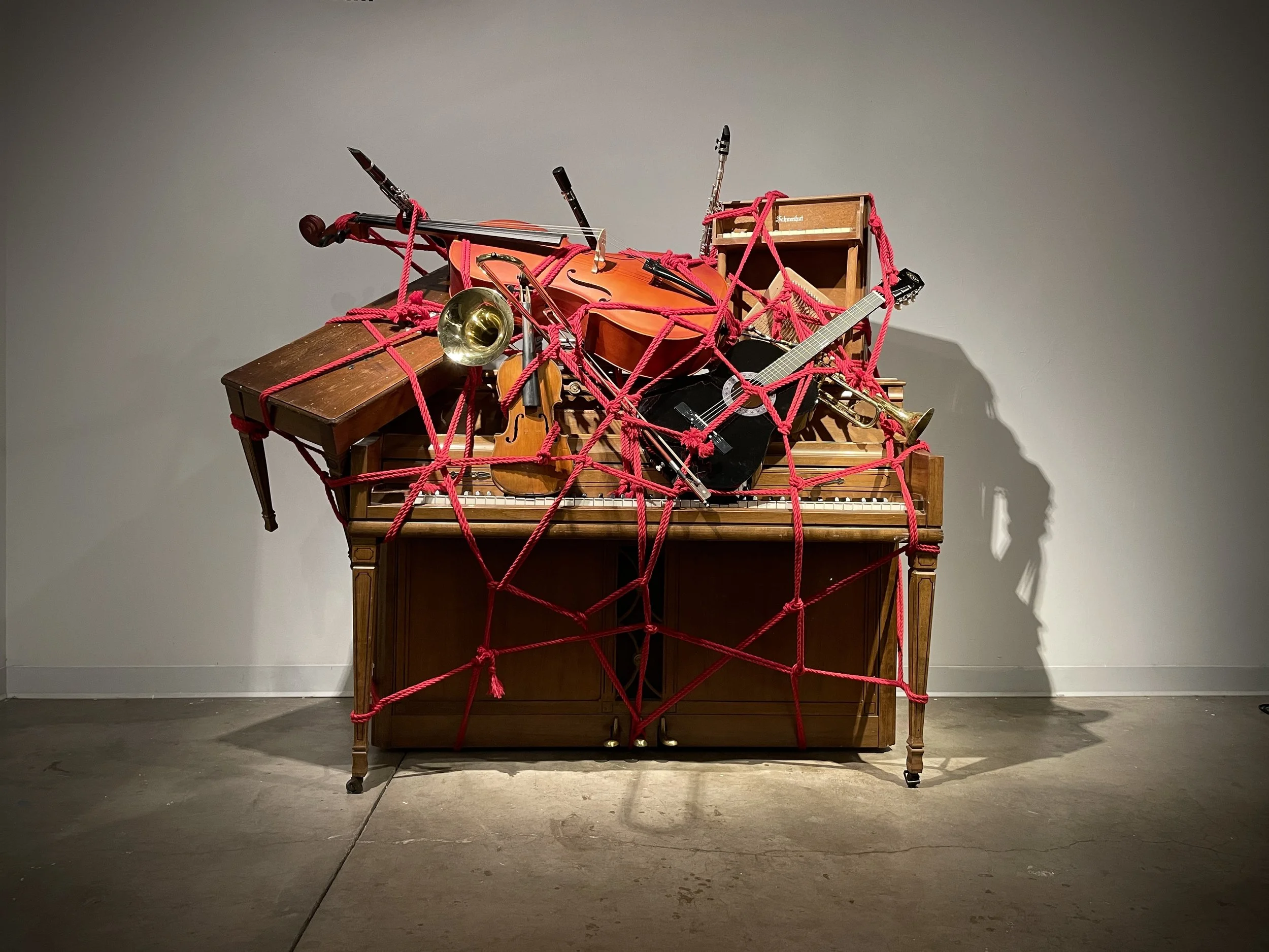 A History of Western Music, 2026, sculpture with found instruments and bondage rope. 